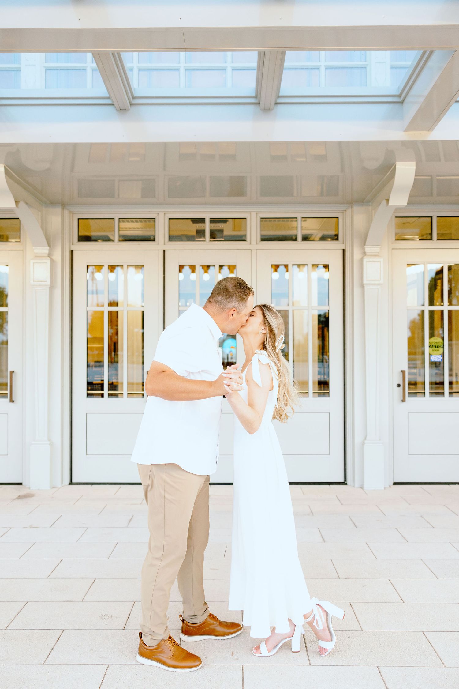Engaged couple kissing at Michigan Central Station in Detroit, MI