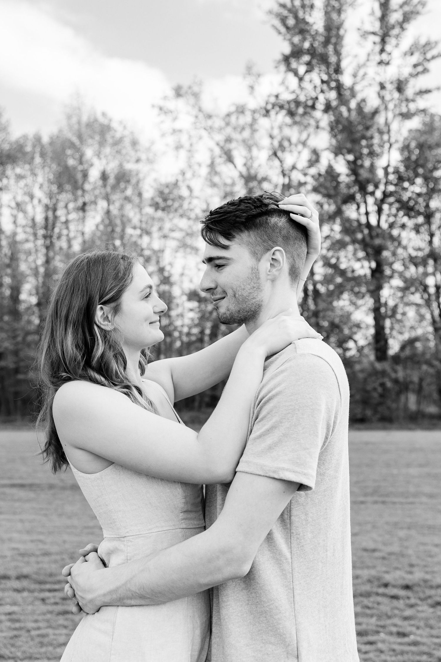 Engaged couple embracing at DeBuck's tulip field spring engagement session in Belleville, MI