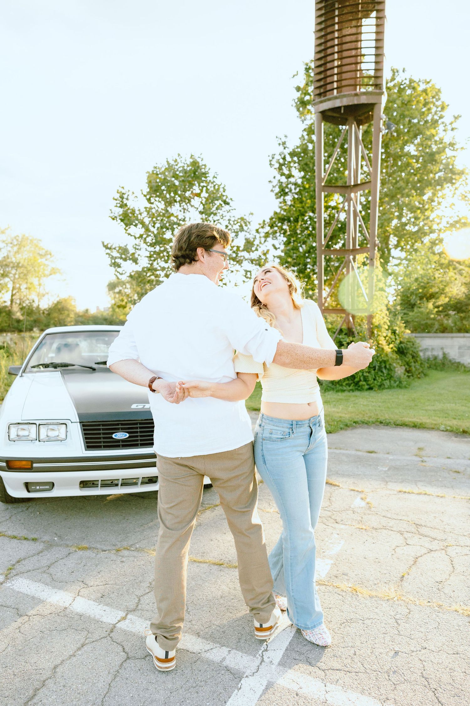 Engaged couple swing dancing at Belle Isle summer engagement session in Detroit, MI