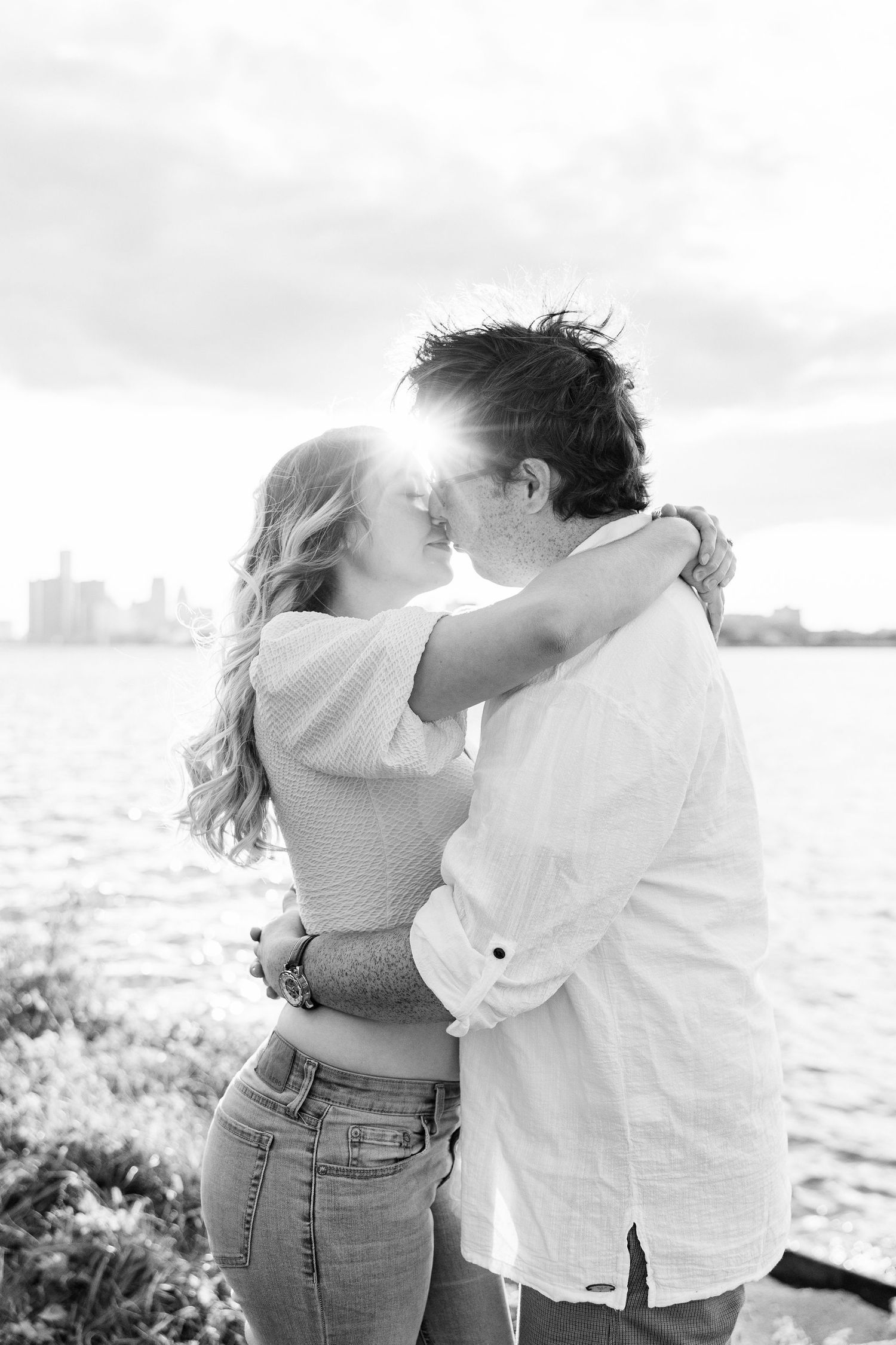 Engaged couple embracing at Belle Isle summer engagement session in Detroit, MI