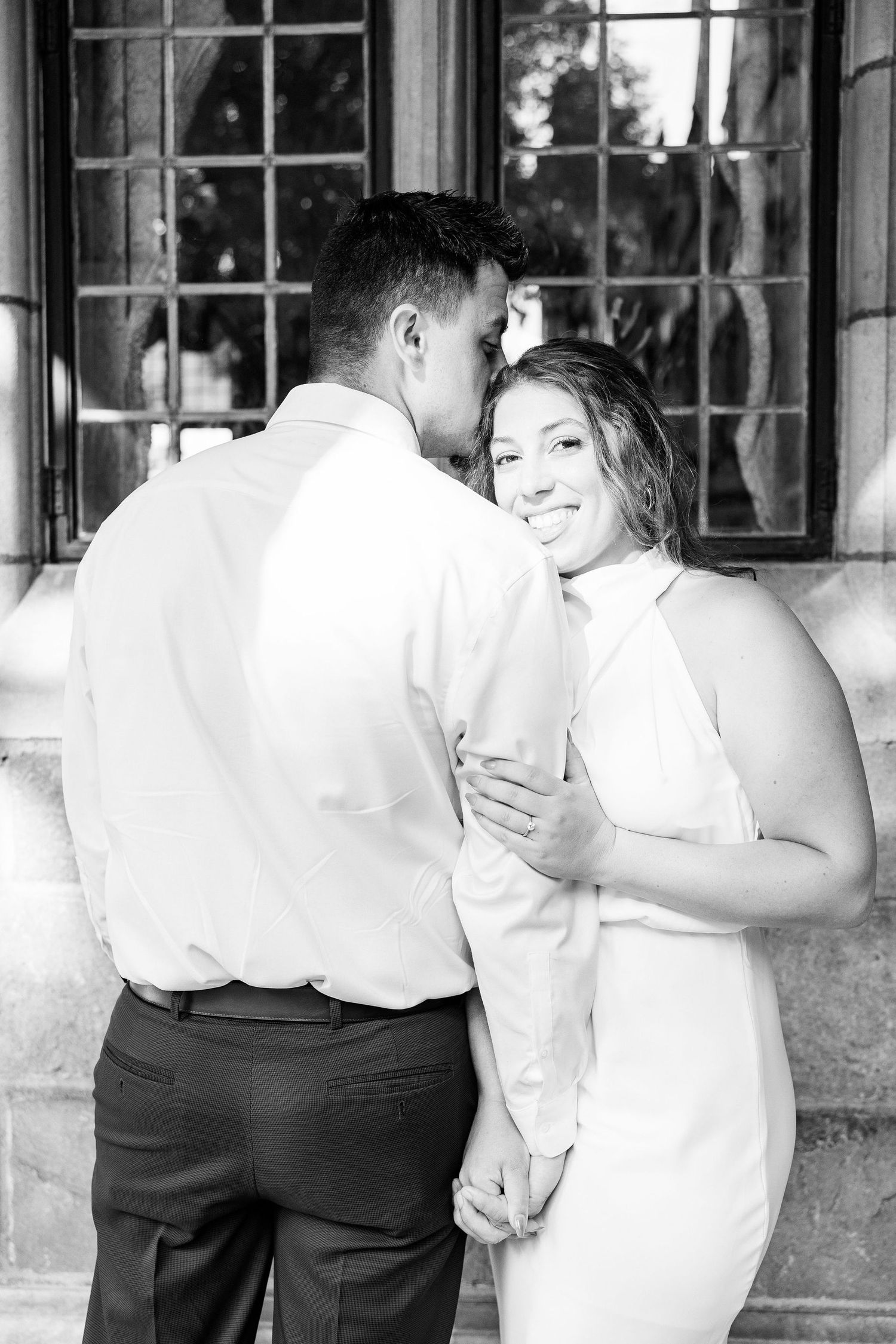 Engaged couple embracing at the University of Michigan Law Quad engagement session in Ann Arbor, MI