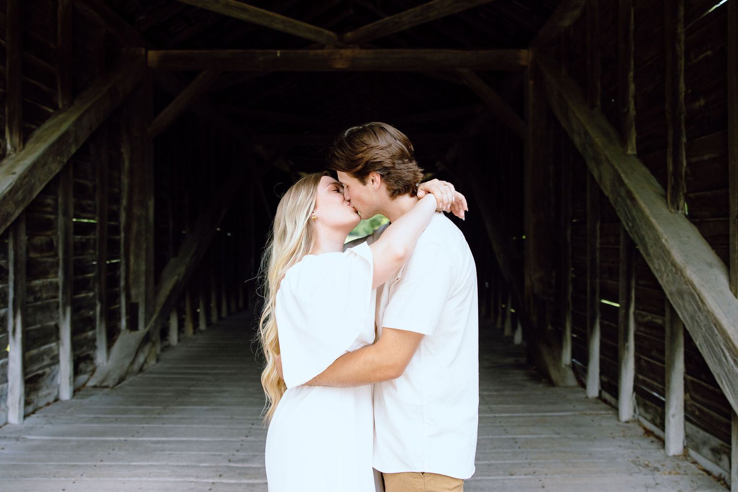 Engaged couple kissing at Greenfield Village in Dearborn, MI