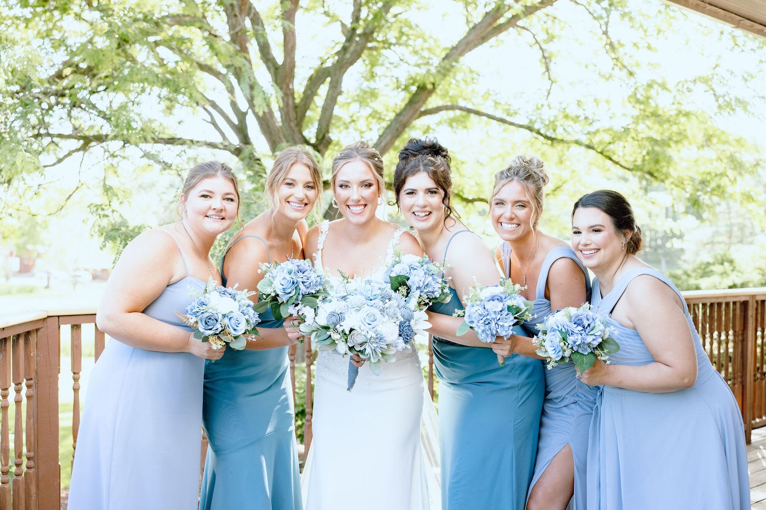Bride and bridesmaids standing in a line at Lapeer Country Club wedding in Michigan