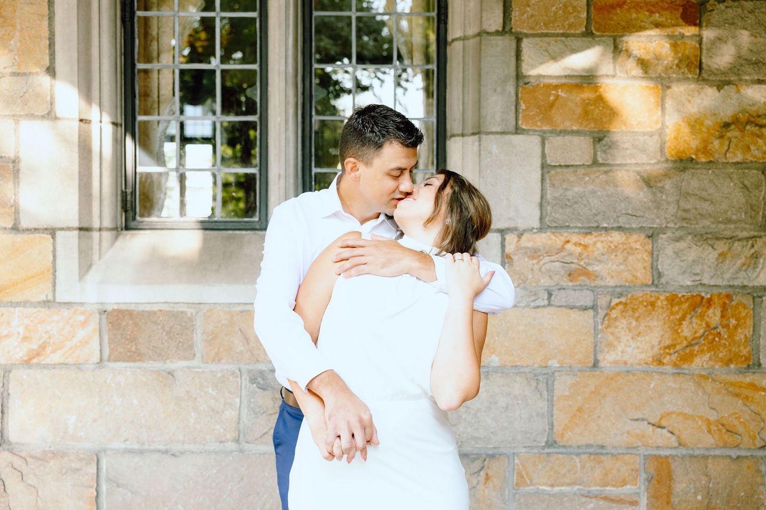 Engaged couple kissing at the University of Michigan Law Quad engagement session in Ann Arbor, MI