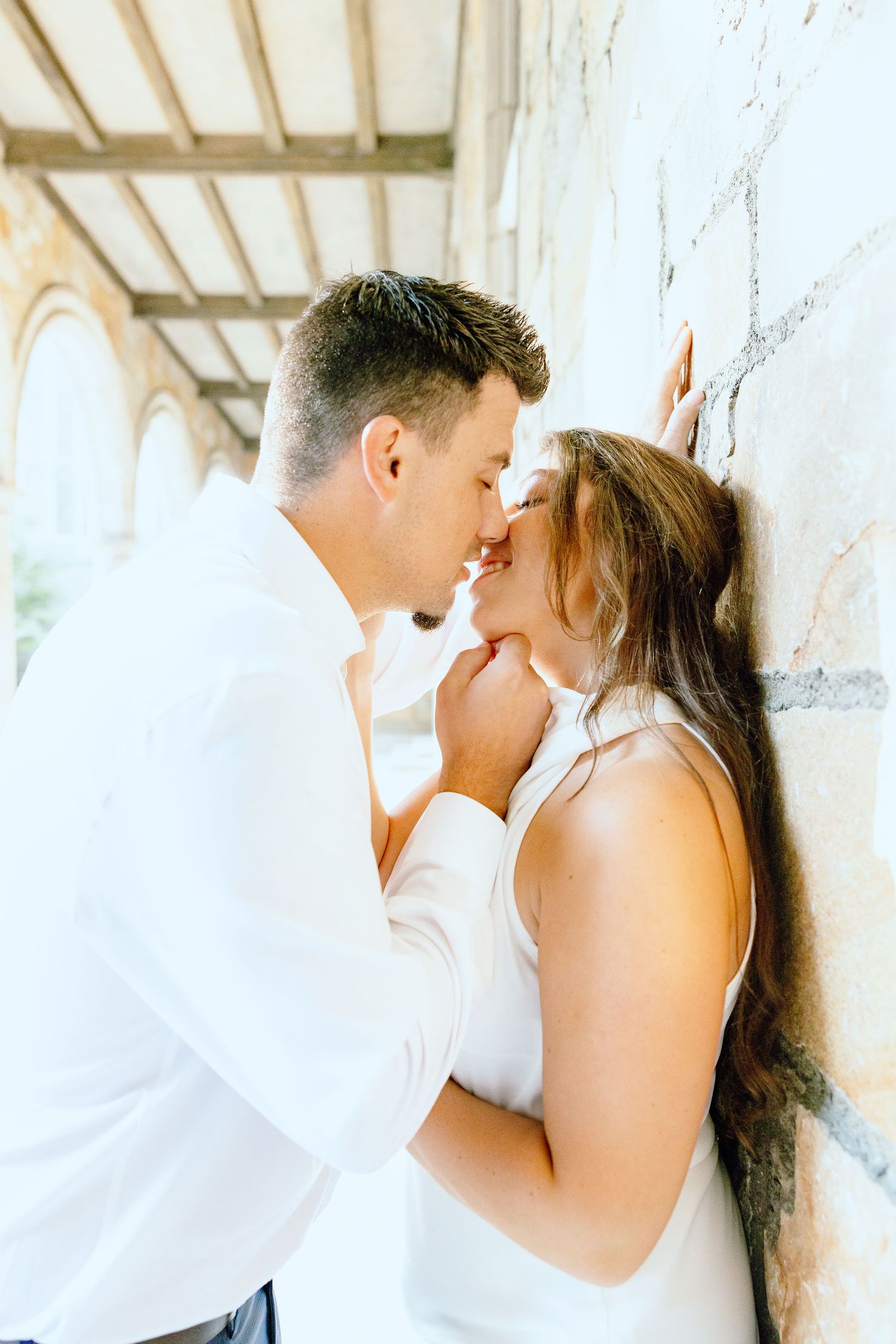 Engaged couple embracing at the University of Michigan Law Quad engagement session in Ann Arbor, MI