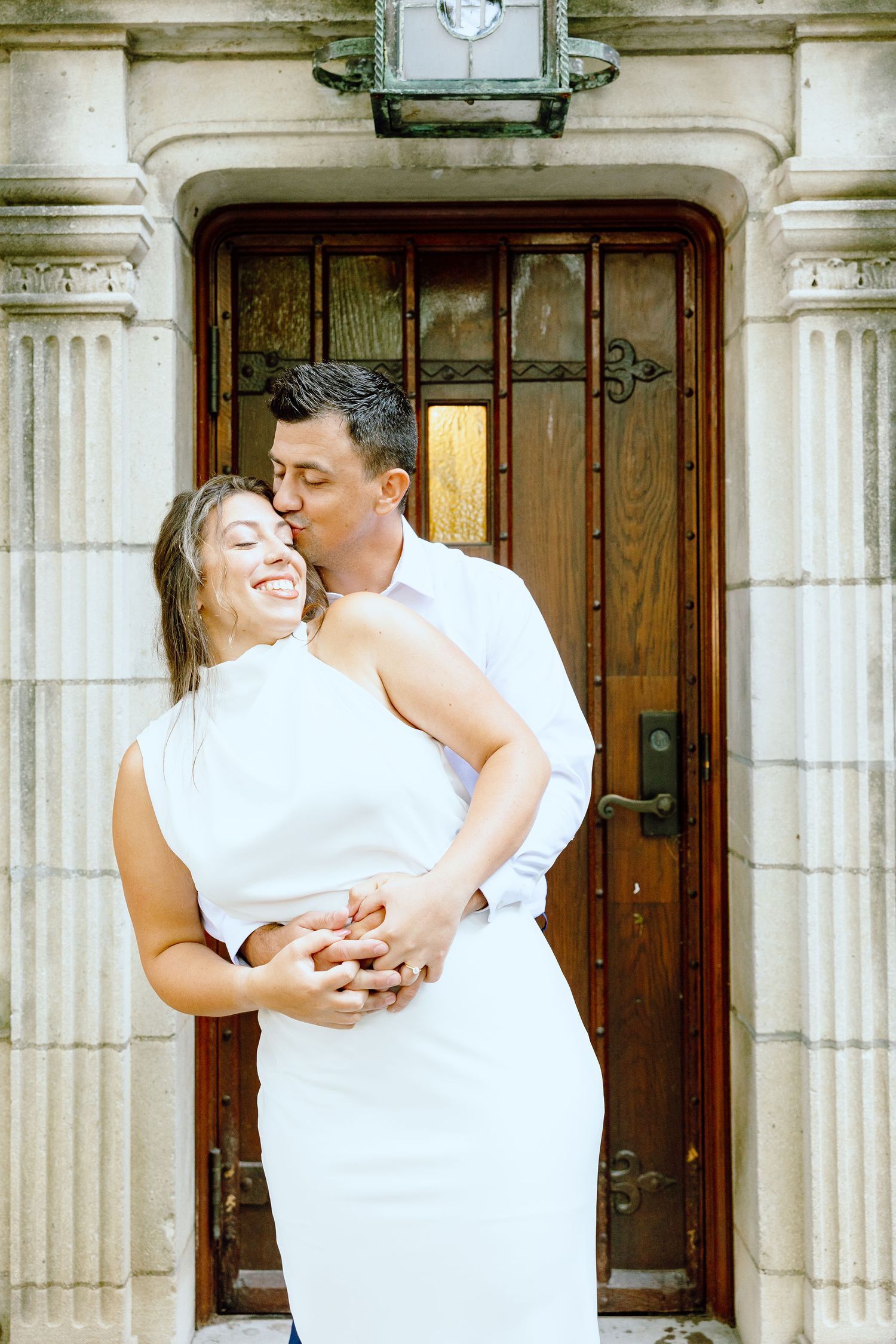Engaged couple embracing at the University of Michigan Law Quad engagement session in Ann Arbor, MI