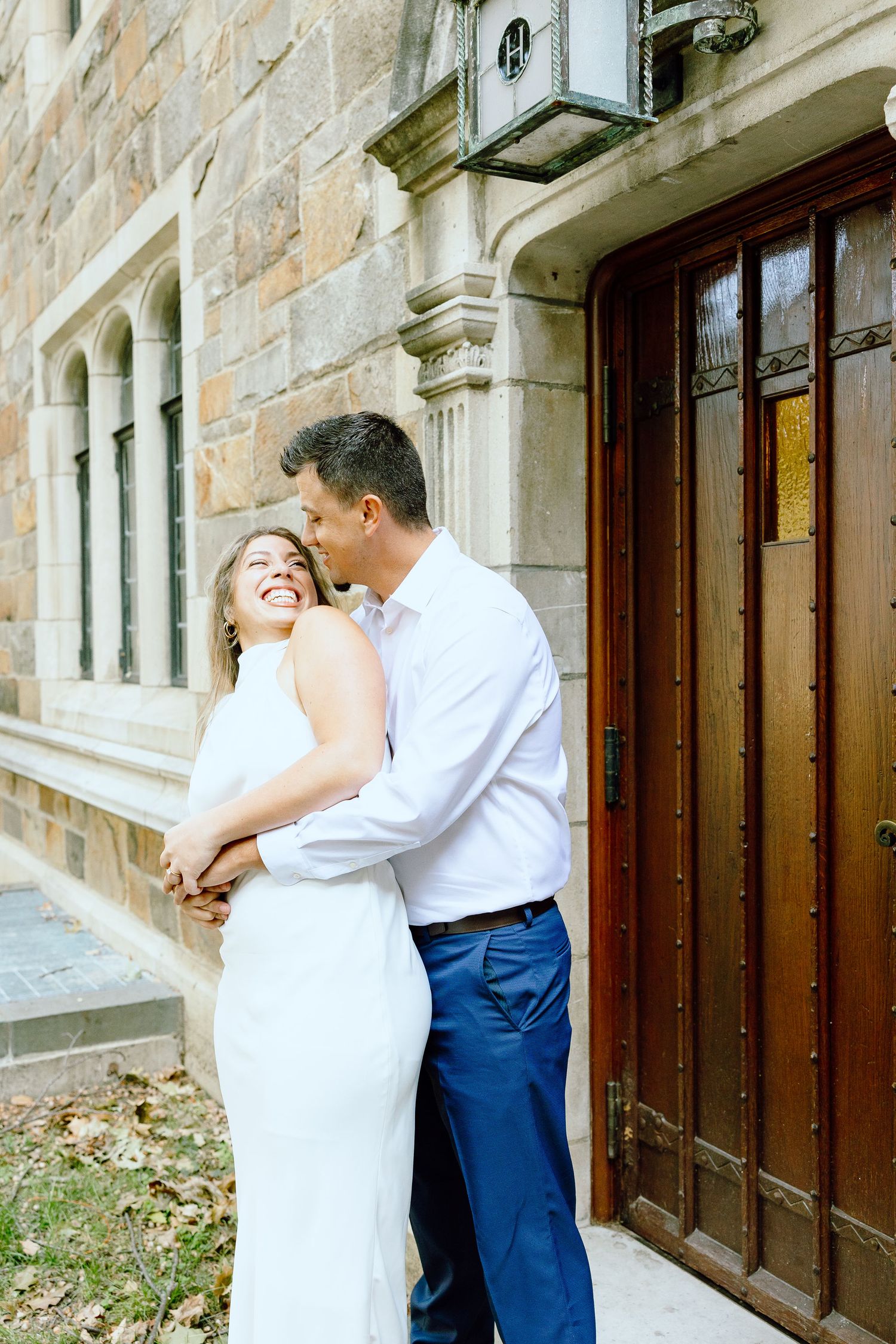 Engaged couple embracing at the University of Michigan Law Quad engagement session in Ann Arbor, MI