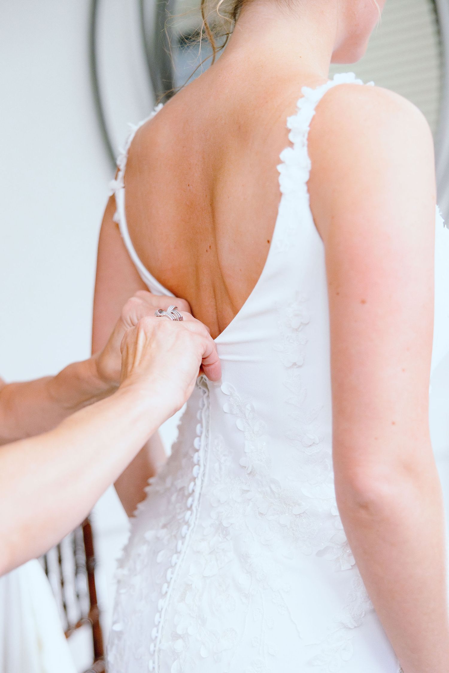 Bride getting into dress at Lapeer Country Club wedding in Michigan