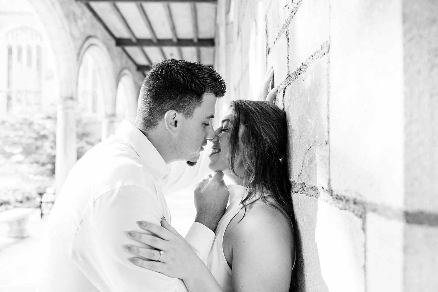 Engaged couple embracing at the University of Michigan Law Quad engagement session in Ann Arbor, MI