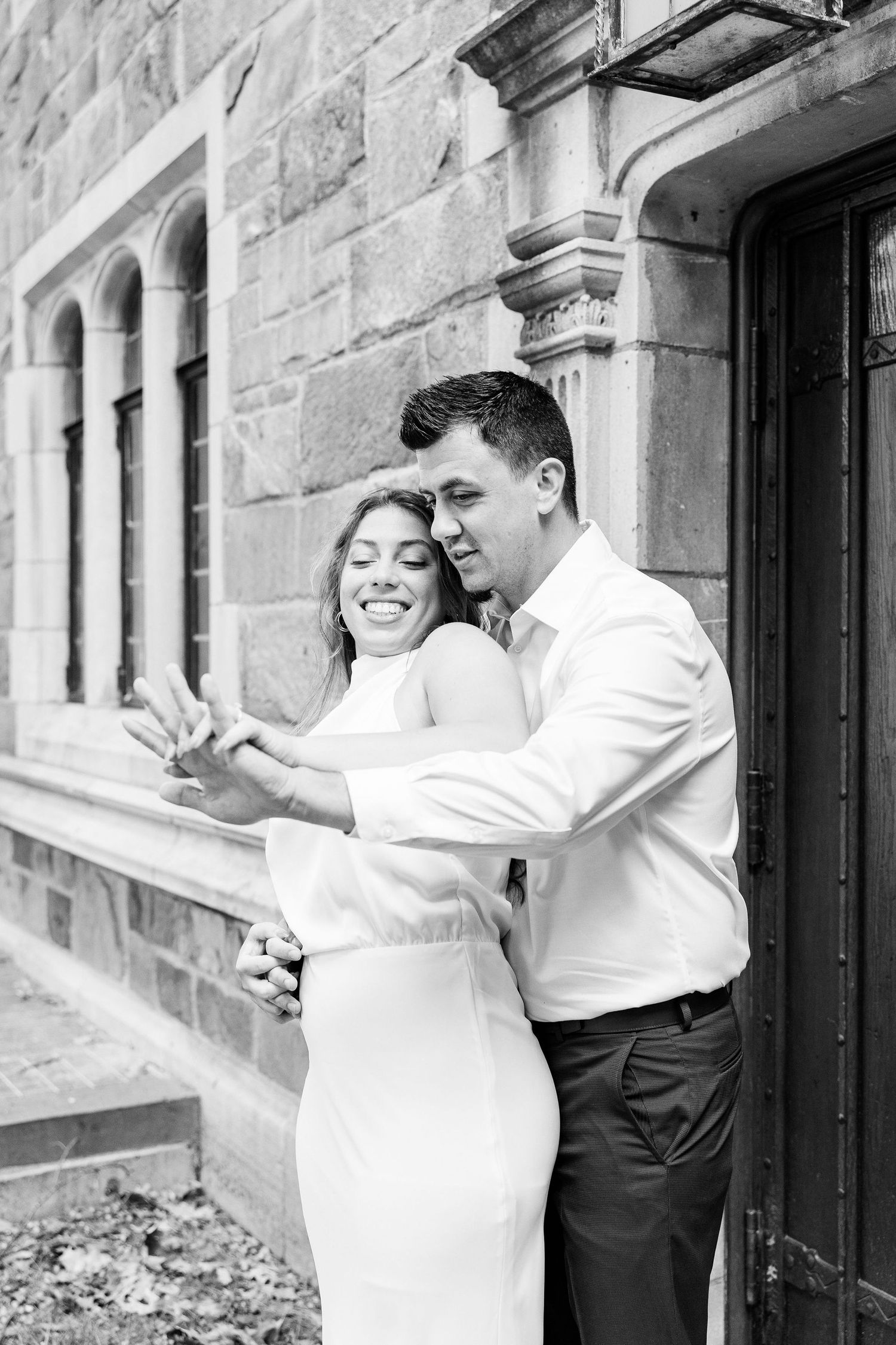 Engaged couple embracing at the University of Michigan Law Quad engagement session in Ann Arbor, MI