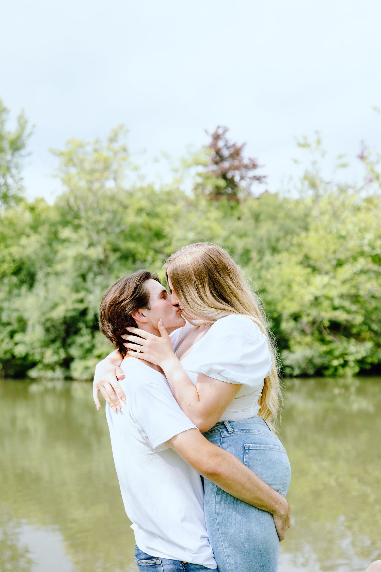 Engaged couple kissing at Greenfield Village in Dearborn, MI