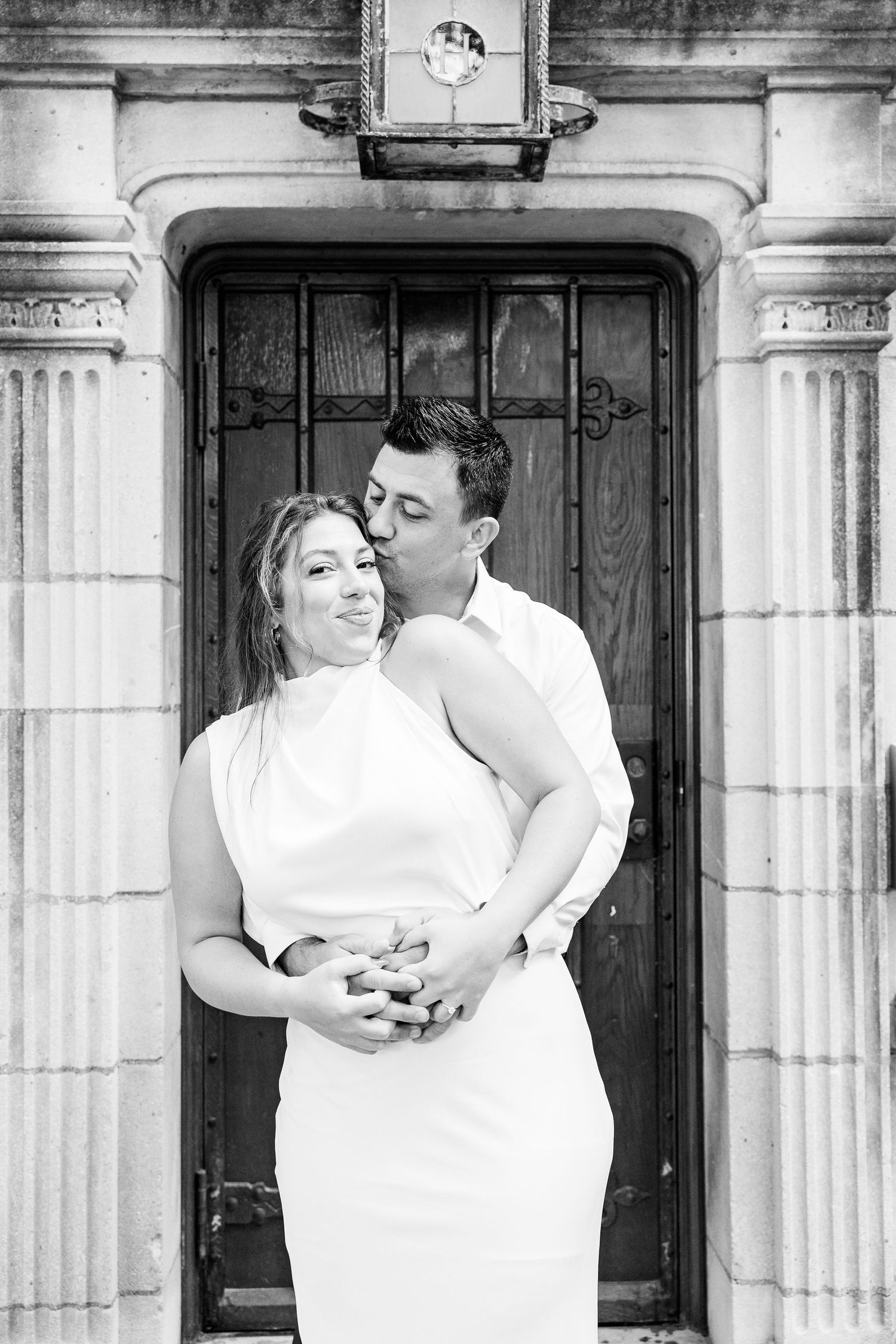 Engaged couple embracing at the University of Michigan Law Quad engagement session in Ann Arbor, MI