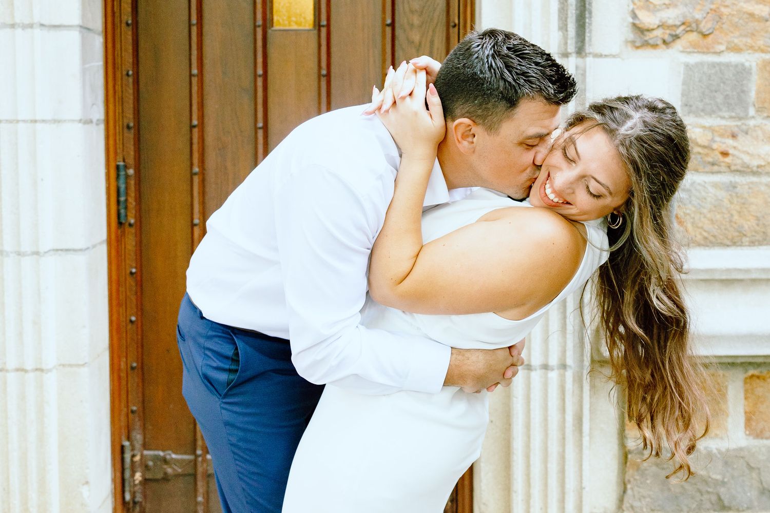 Engaged couple embracing at the University of Michigan Law Quad engagement session in Ann Arbor, MI