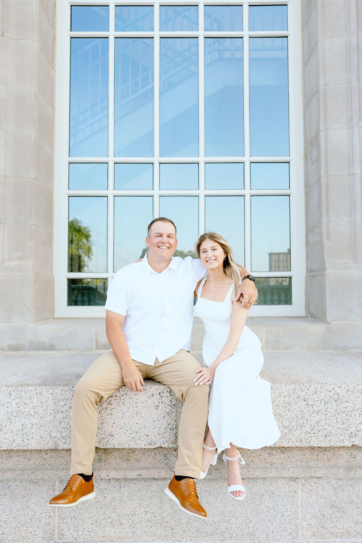 Engaged couple embracing at Michigan Central Station summer engagement session in Detroit, MI