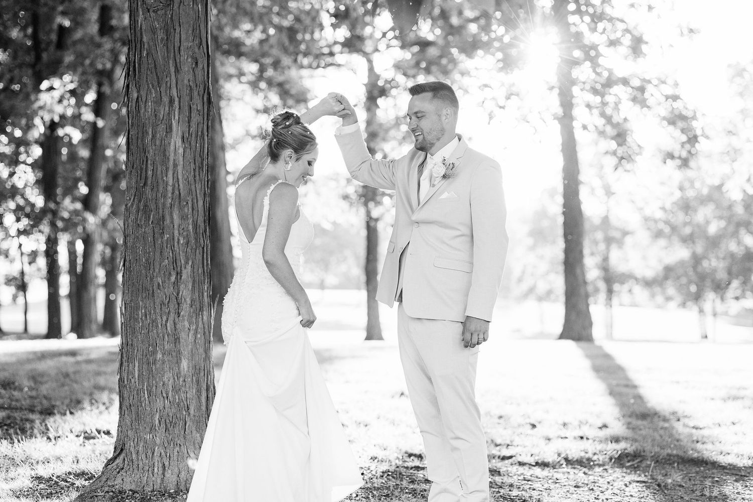 Married couple twirling during golden hour at Lapeer Country Club wedding in Michigan