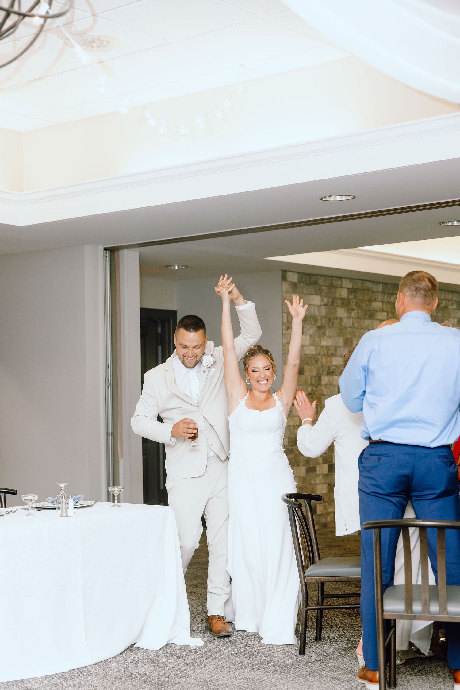 Married couple entering reception at Lapeer Country Club wedding in Michigan