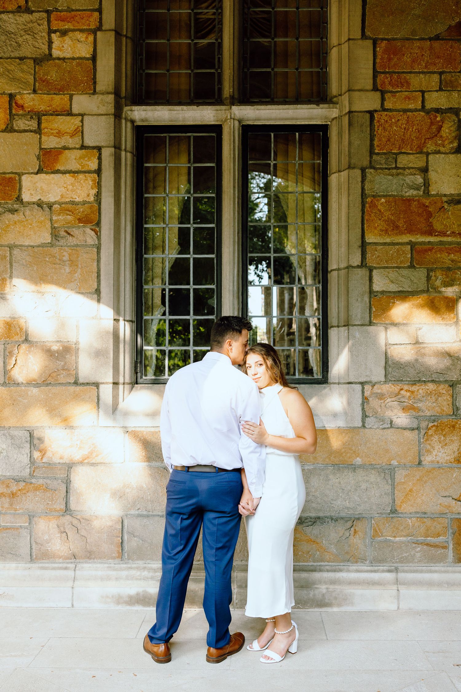 Engaged couple embracing at the University of Michigan Law Quad engagement session in Ann Arbor, MI