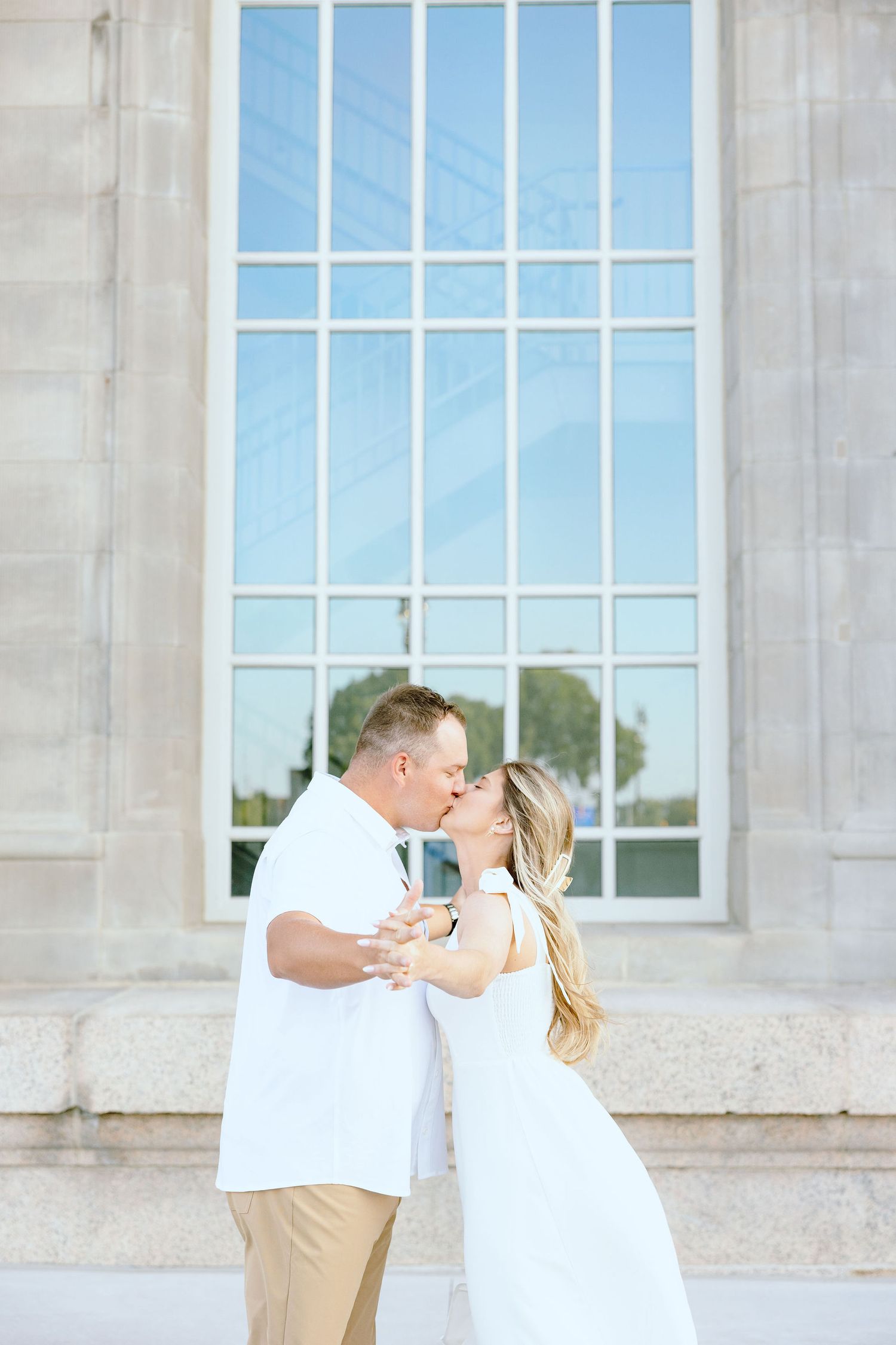 Engaged couple kissing at Michigan Central Station in Detroit, MI