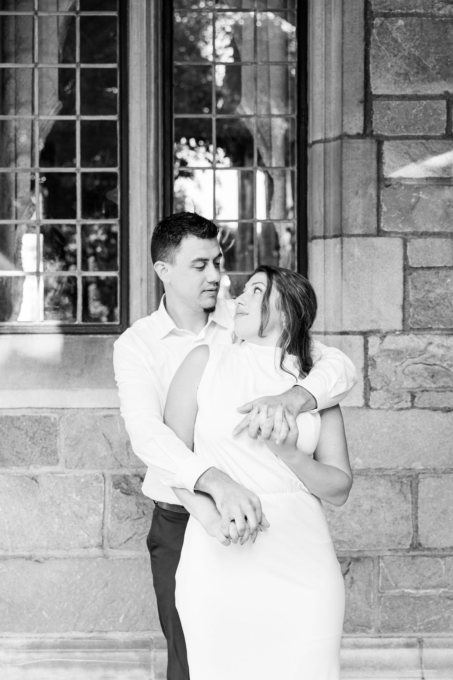 Engaged couple embracing at the University of Michigan Law Quad engagement session in Ann Arbor, MI