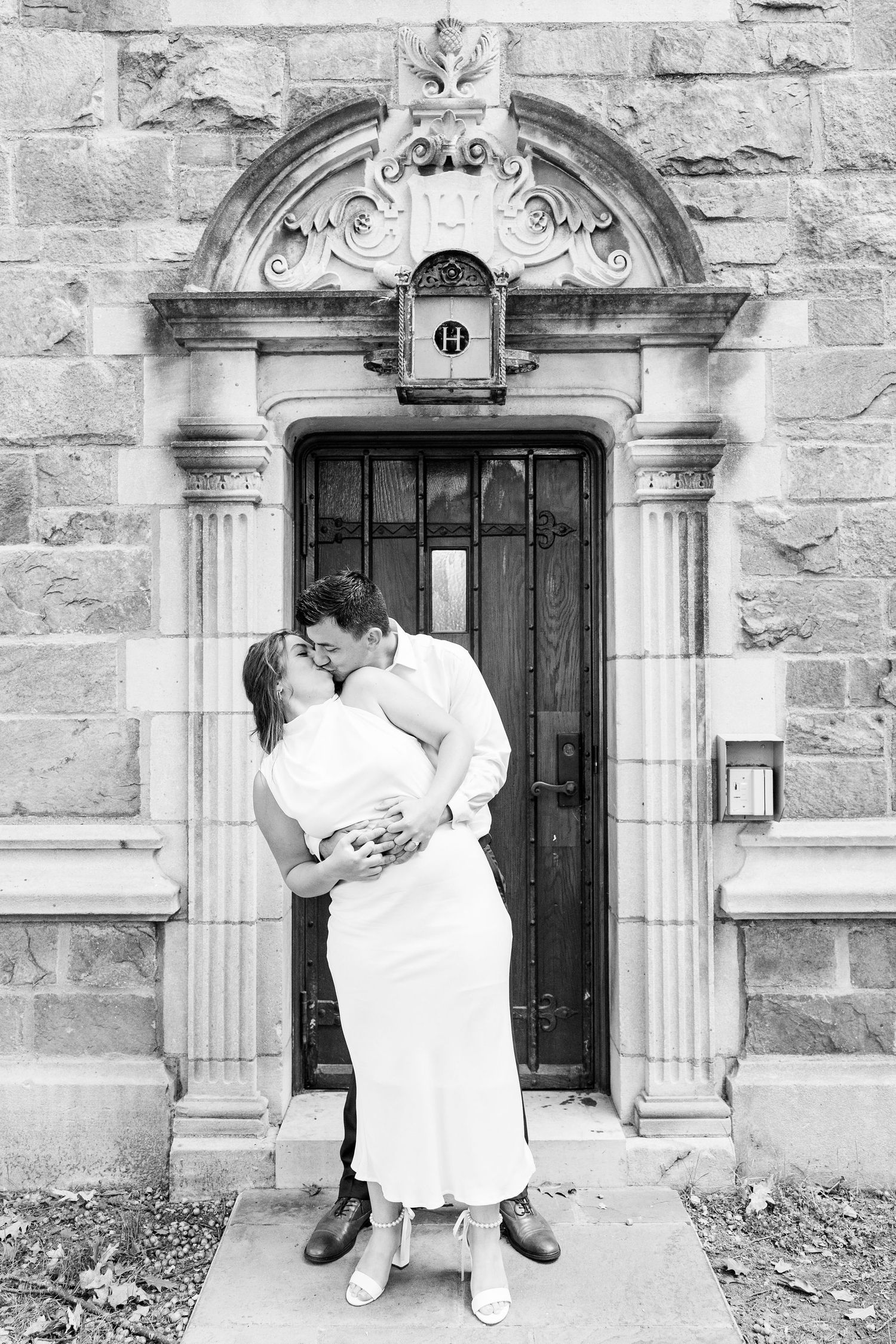 Engaged couple embracing at the University of Michigan Law Quad engagement session in Ann Arbor, MI
