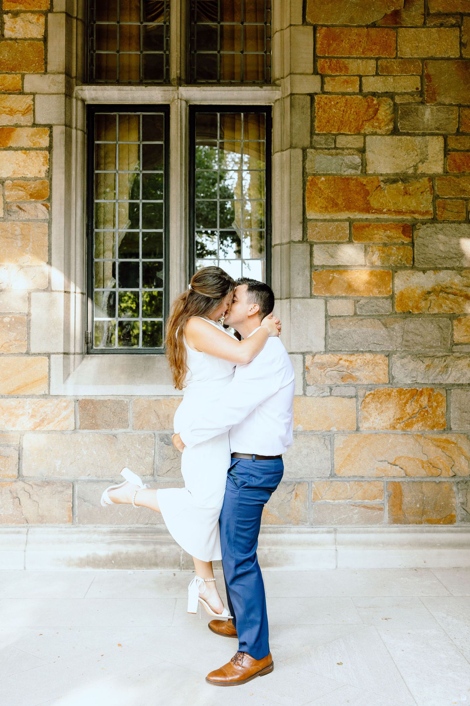 Man lifting woman at the UofM Law Quad engagement session in Ann Arbor, MI