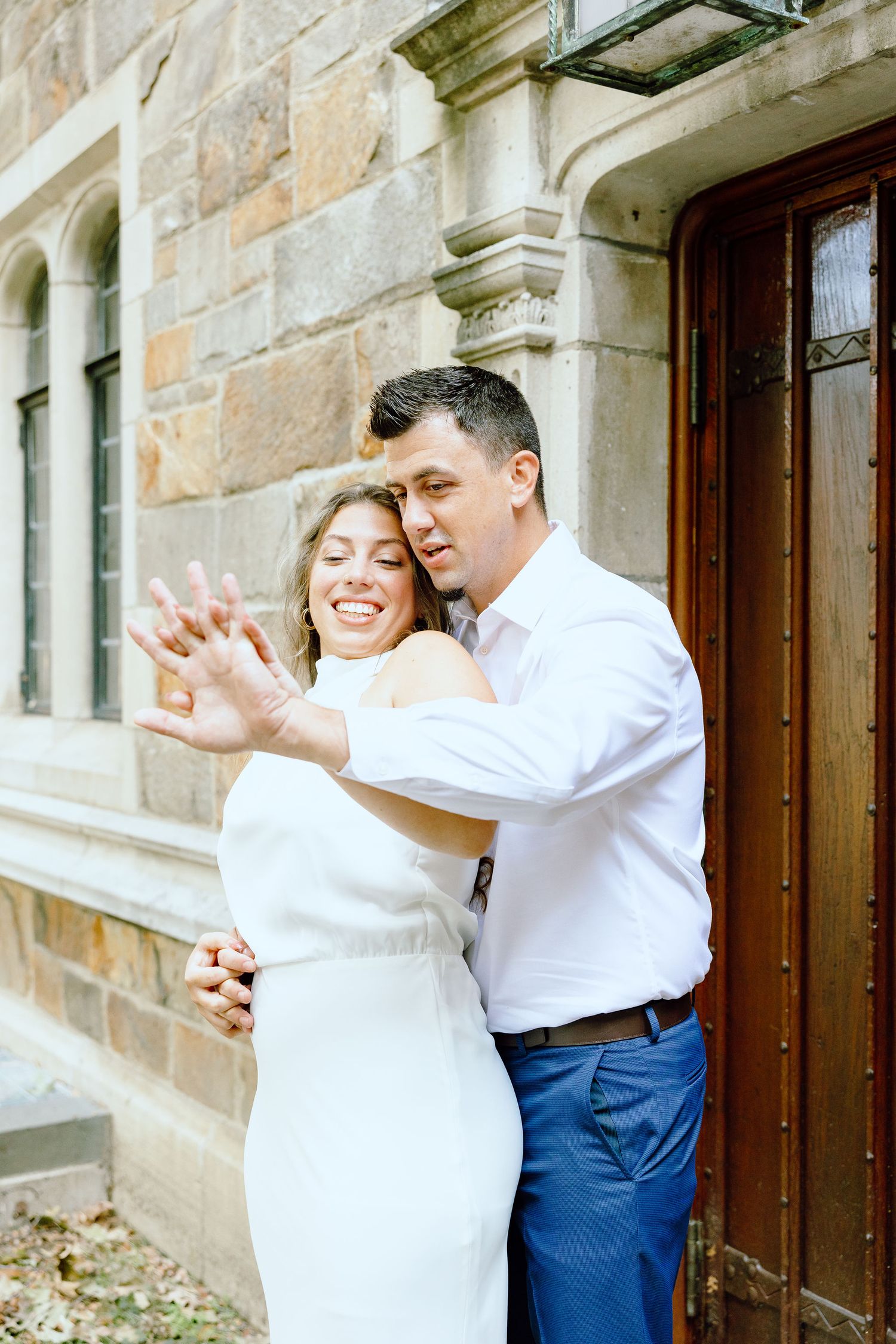 Engaged couple embracing at the University of Michigan Law Quad engagement session in Ann Arbor, MI