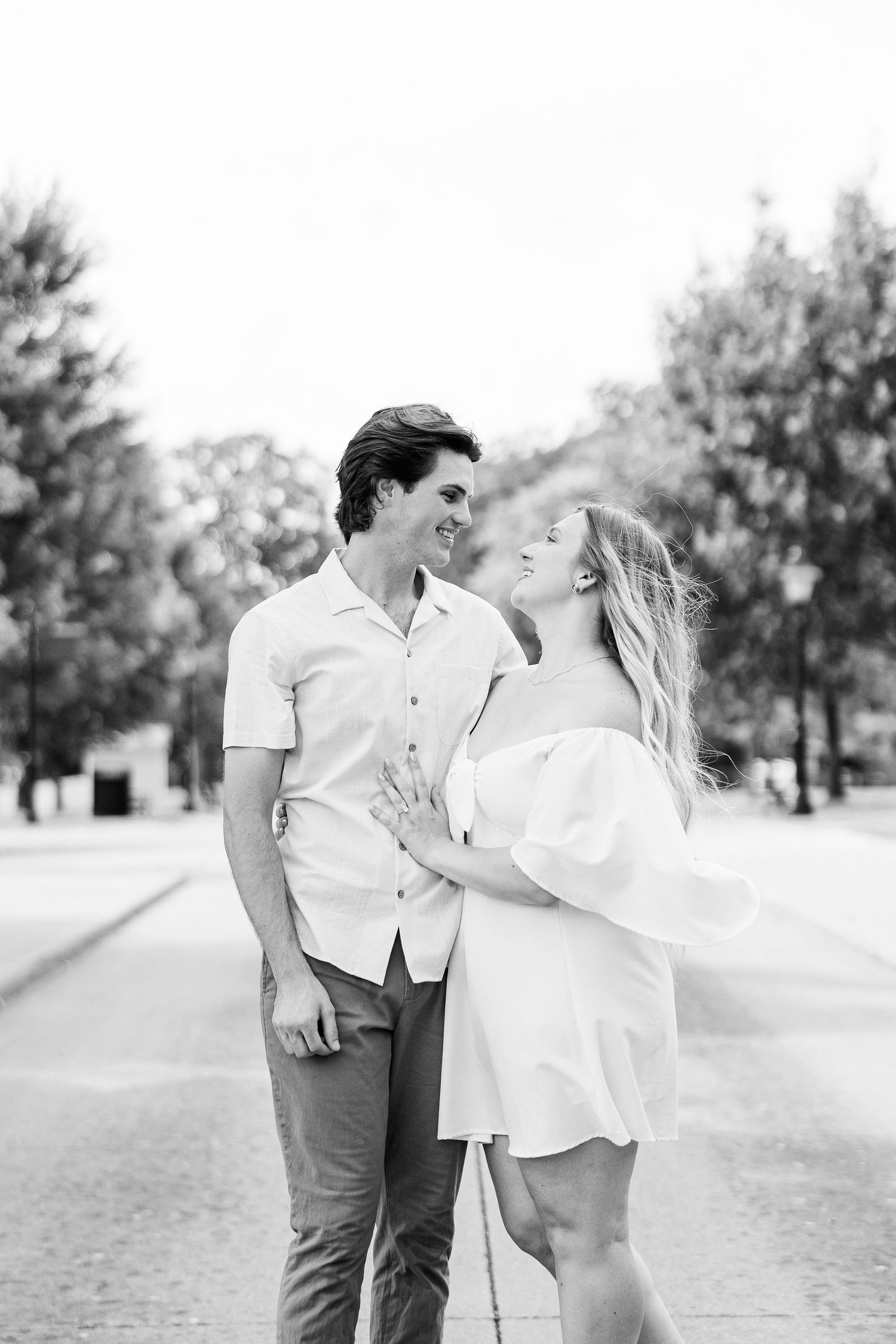 Engaged couple embracing at Greenfield Village in Dearborn, MI