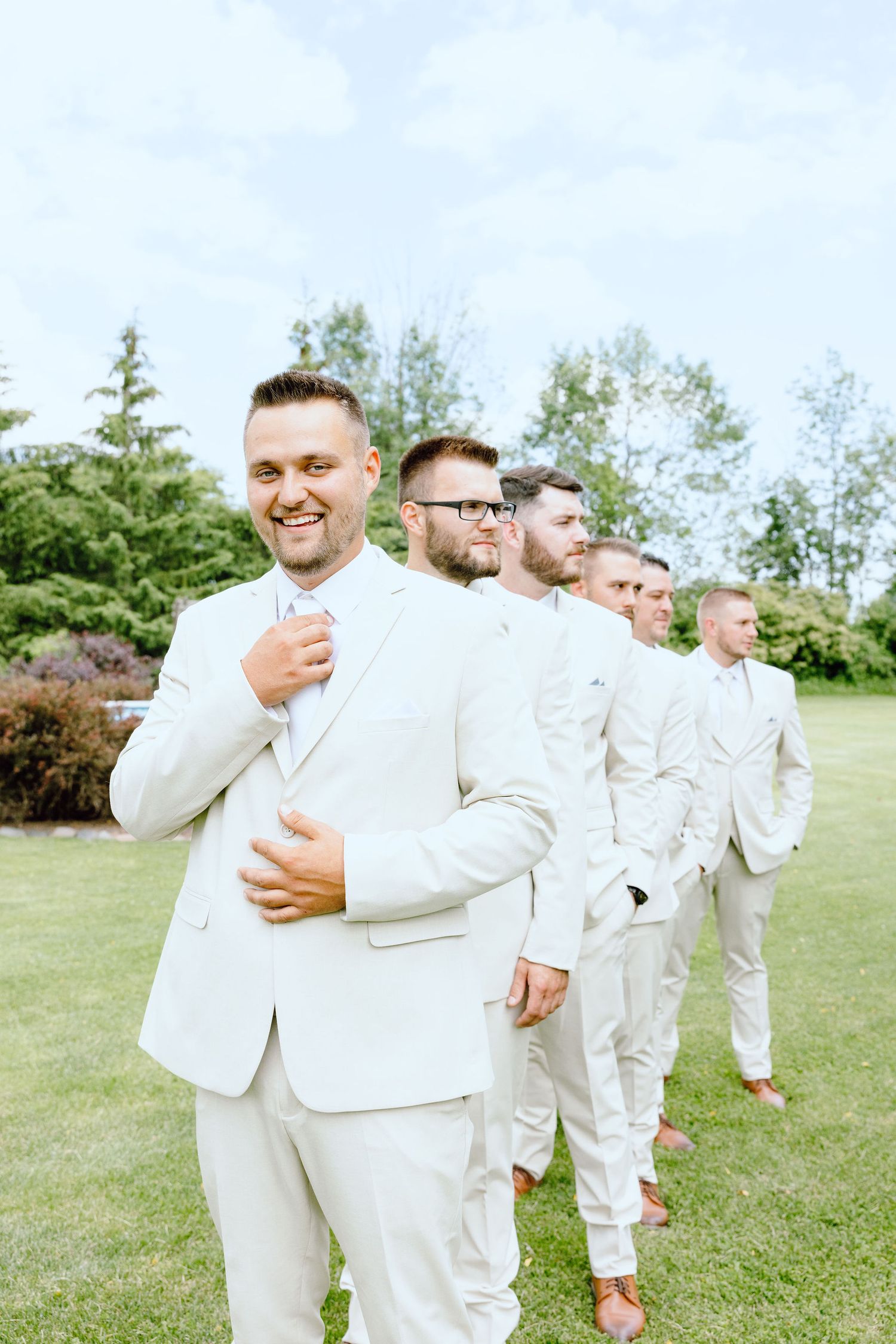 Groomsmen standing in line at Lapeer Country Club wedding in Michigan