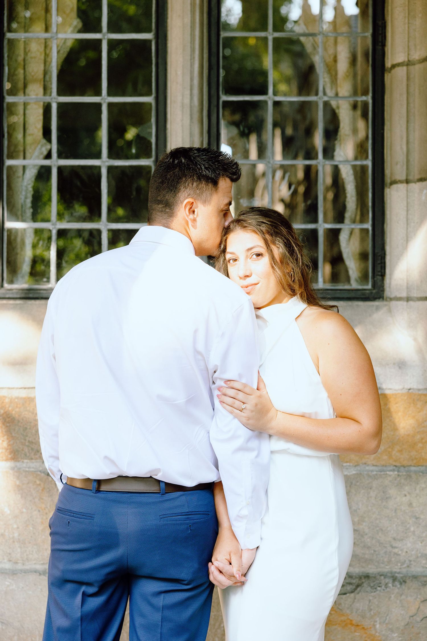 Engaged couple embracing at the University of Michigan Law Quad engagement session in Ann Arbor, MI