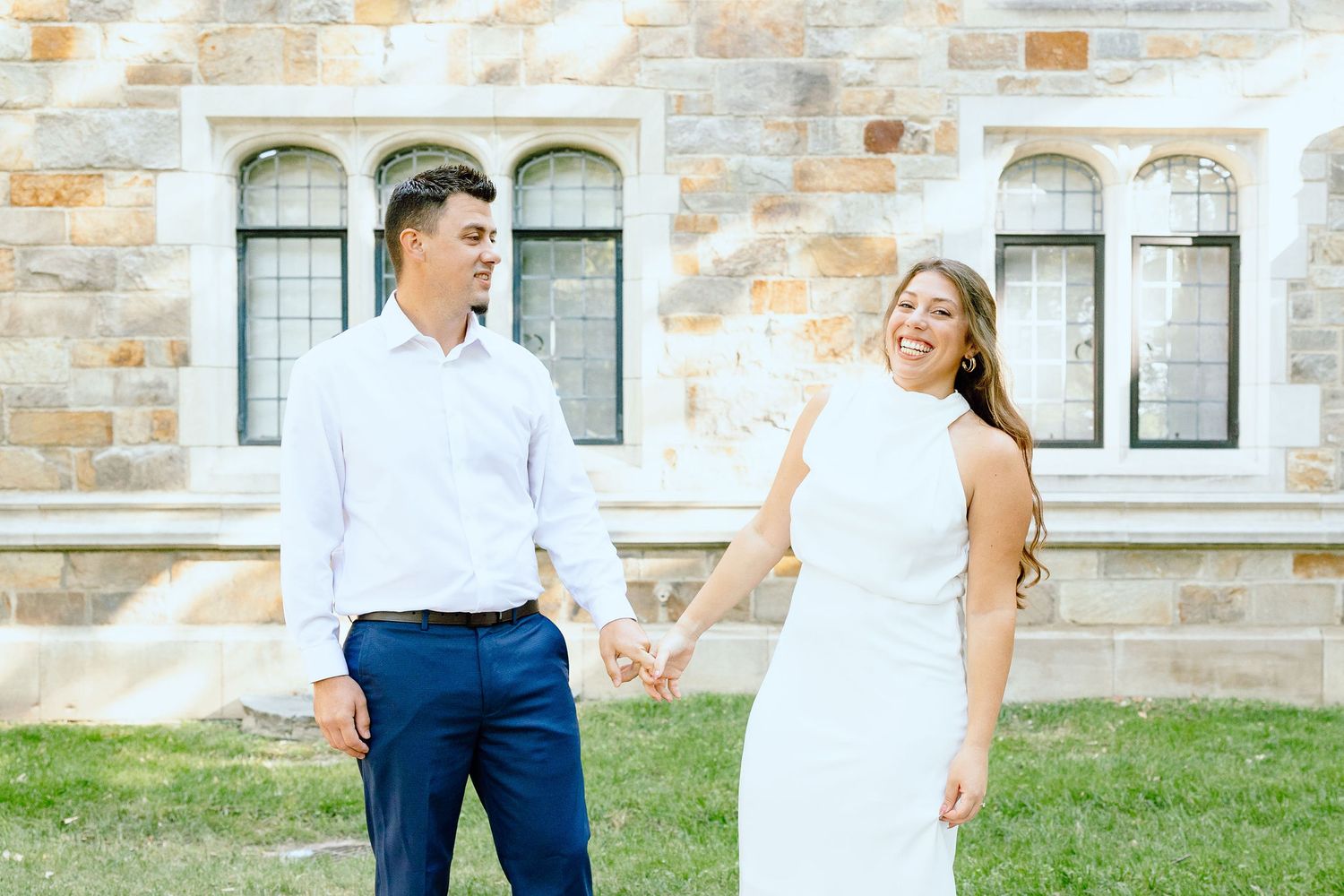 Engaged couple walking and holding hands at the UofM Law Quad engagement session in Ann Arbor, MI