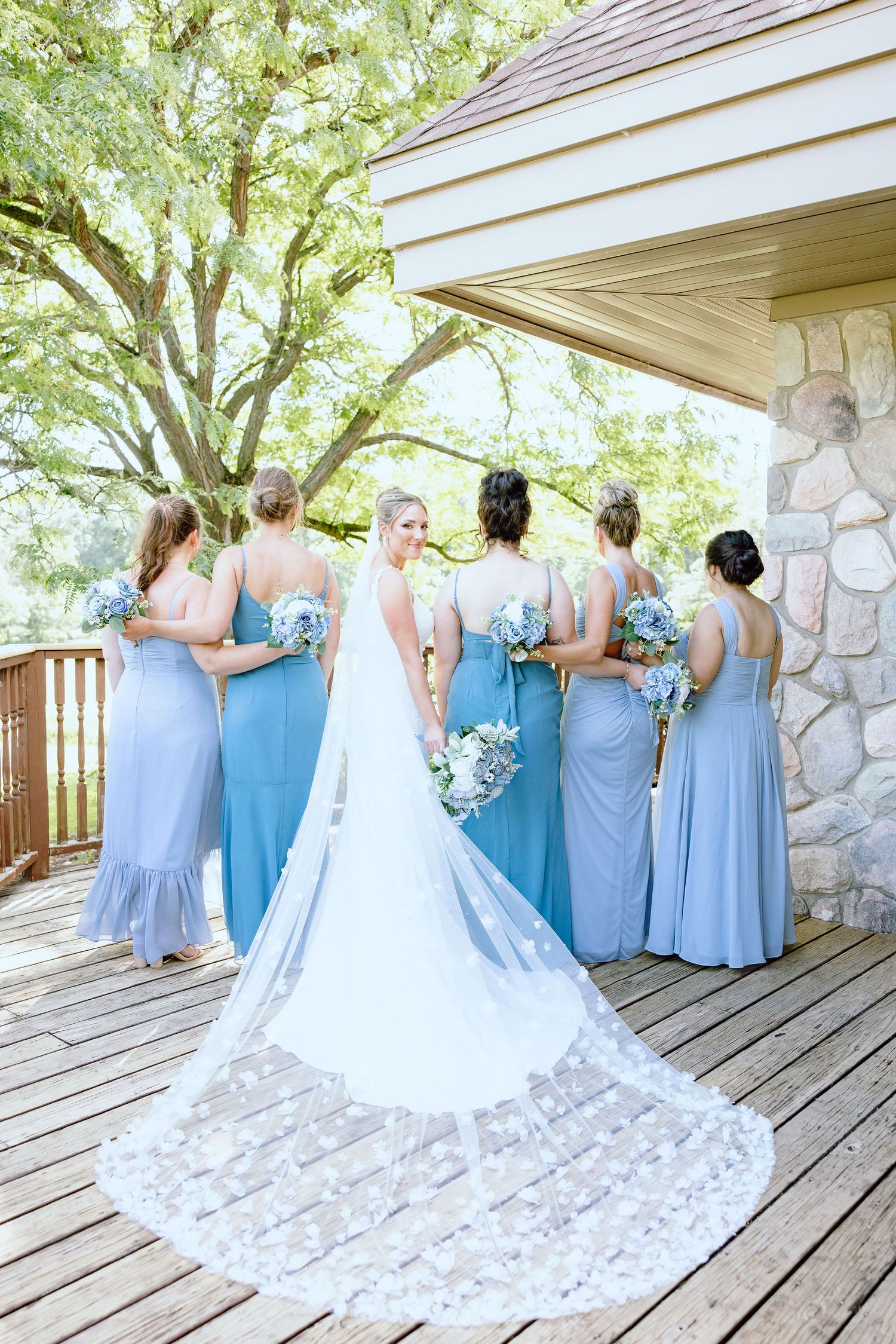 Bride and bridesmaids standing in a line at Lapeer Country Club wedding in Michigan