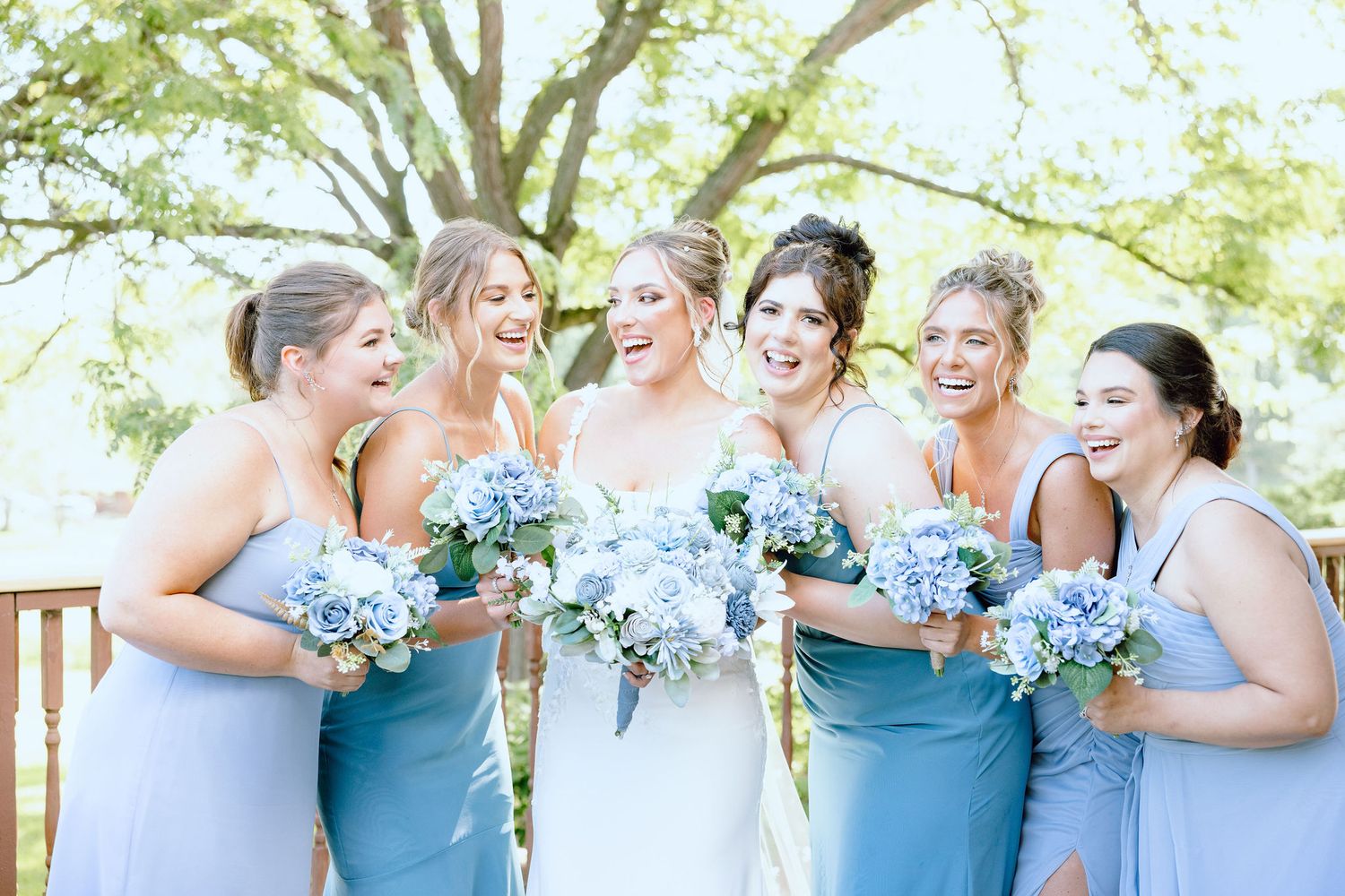 Bride and bridesmaids standing in a line at Lapeer Country Club wedding in Michigan