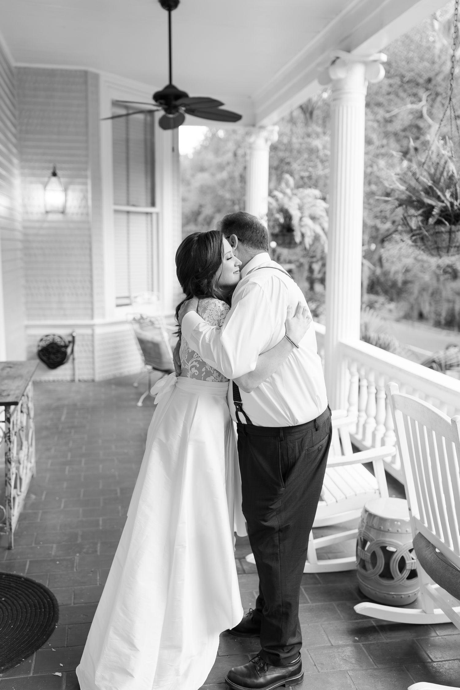 Black and white photos of a father-daughter dance sequence on a white porch during a wedding celebration.