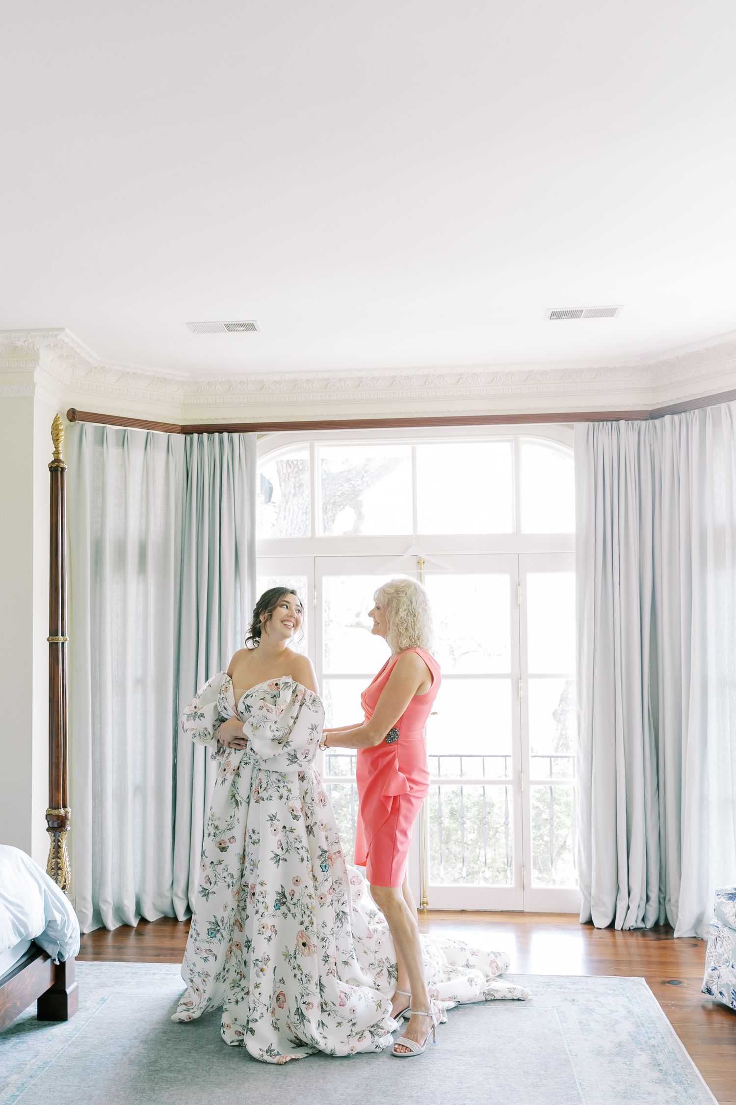 A bright sunlit room with floor-length curtains and elegant interior decor.