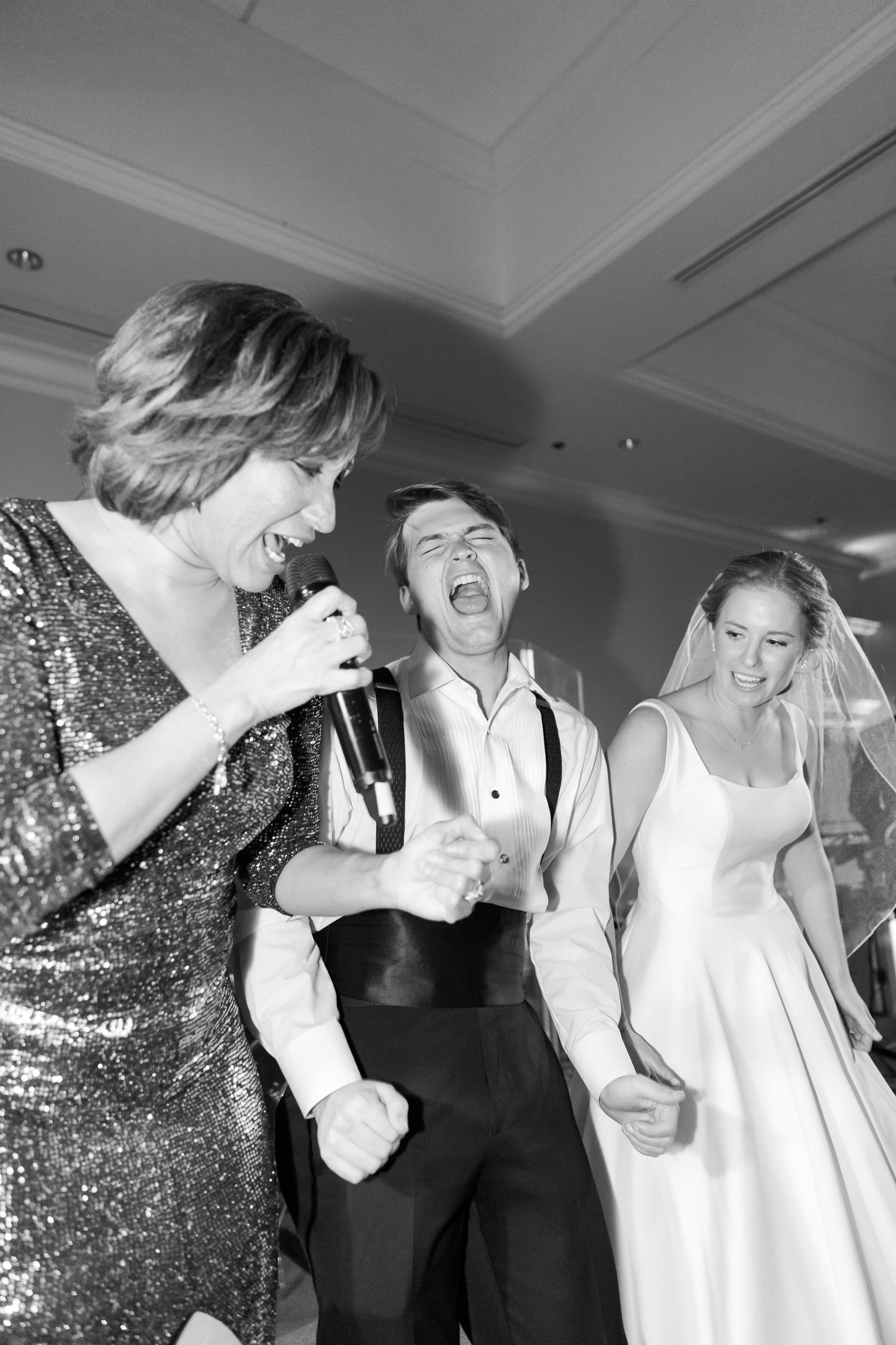 Black and white photos of wedding guests dancing and celebrating at a reception.