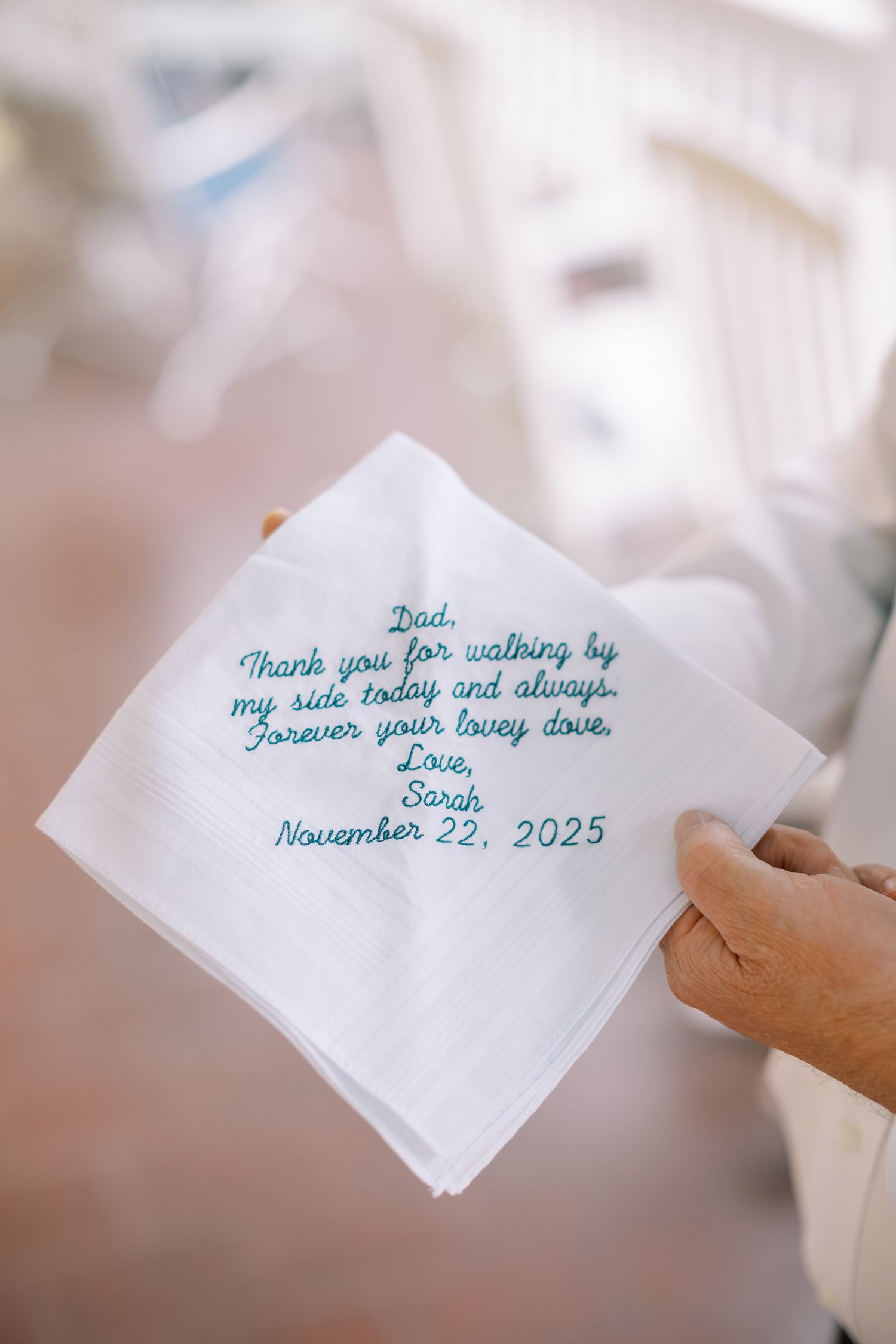 Handwritten notes in blue ink on white handkerchiefs expressing heartfelt wedding day messages.