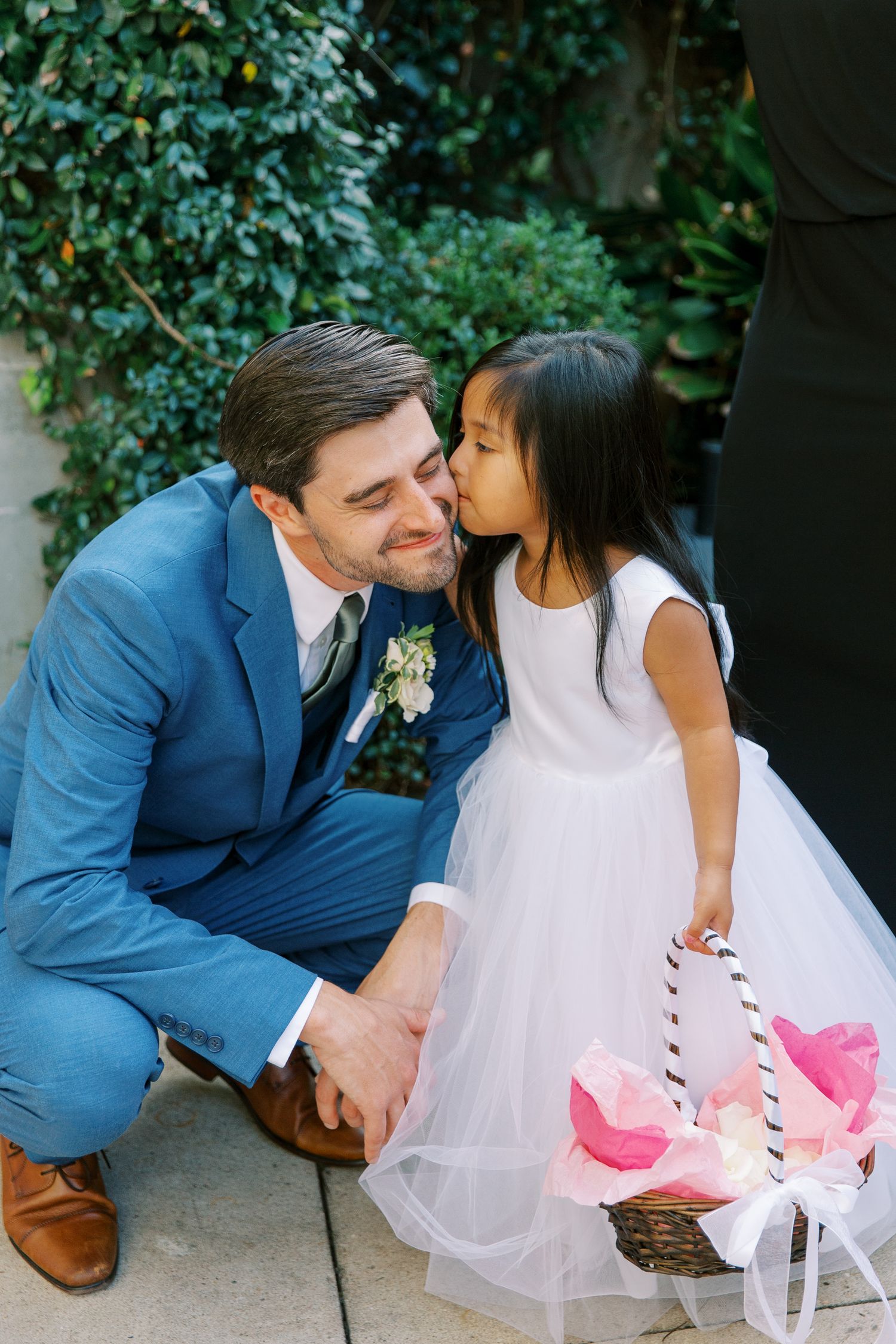 A playful wedding sequence showing a couple in white and blue outfits sharing sweet moments outdoors.