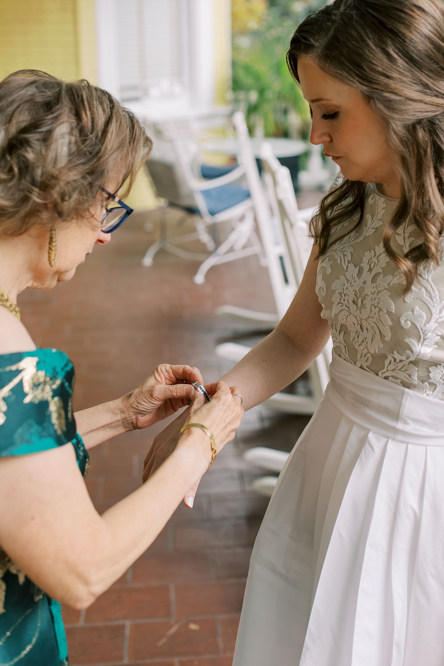 Close-up shots of dress details being adjusted on a front porch.