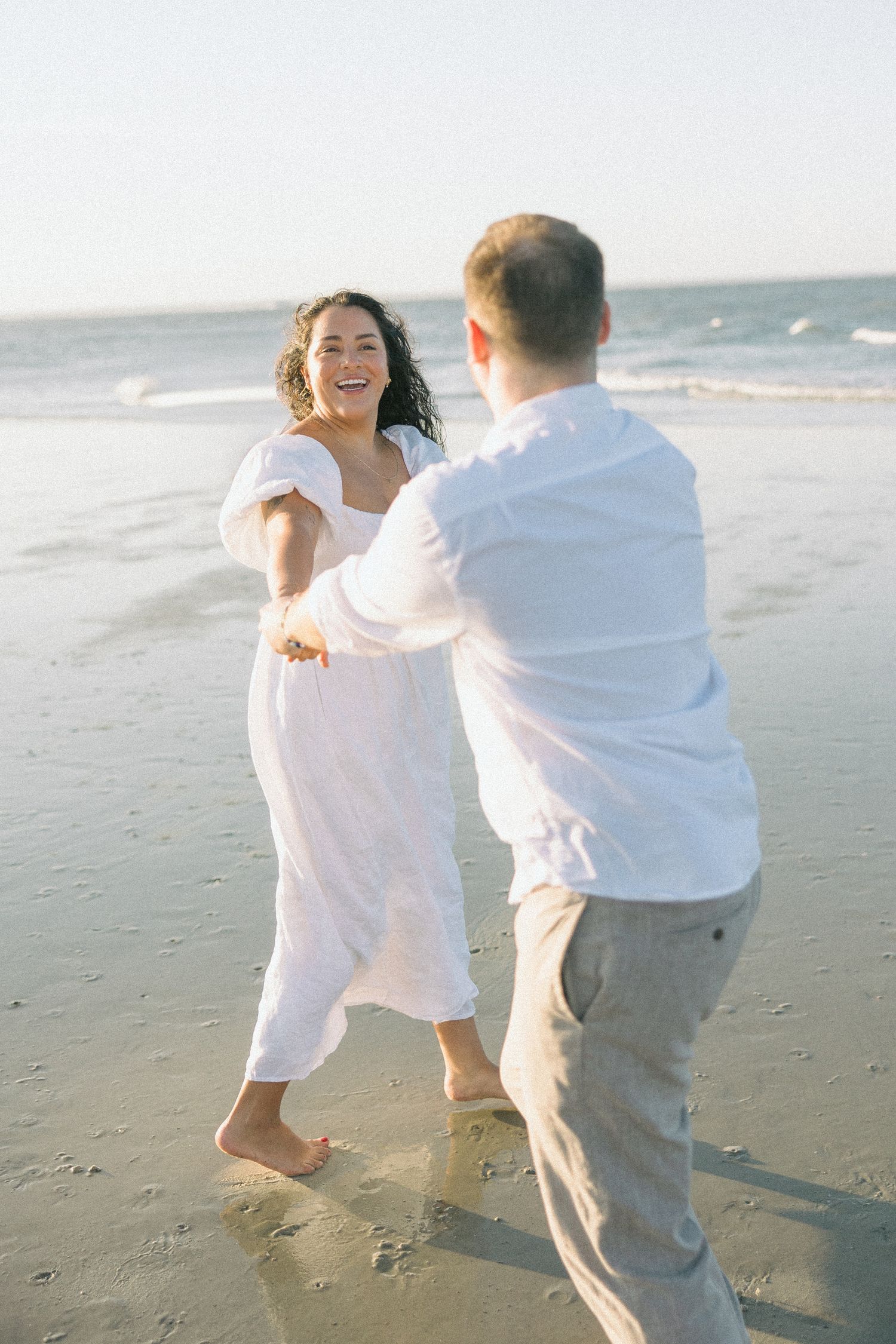 A playful sequence of romantic moments captured on a sunny beach with white clothing and natural lighting.