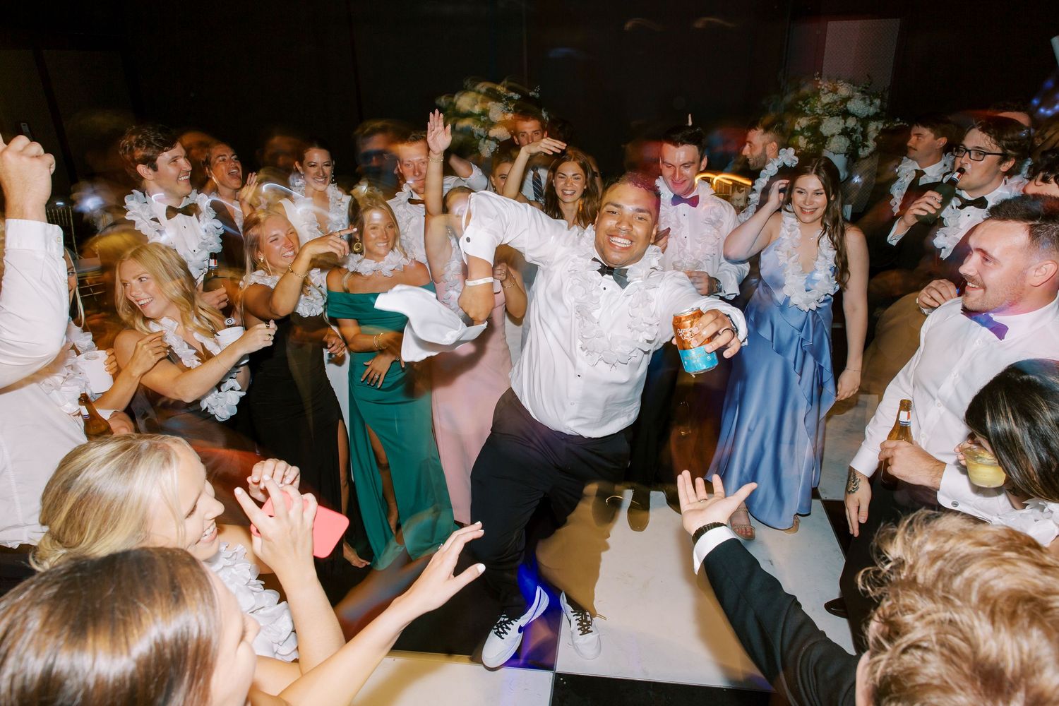 Wedding reception dance party with guests celebrating energetically on the dance floor at the Hyatt Regency Hotel in Savannah, GA.