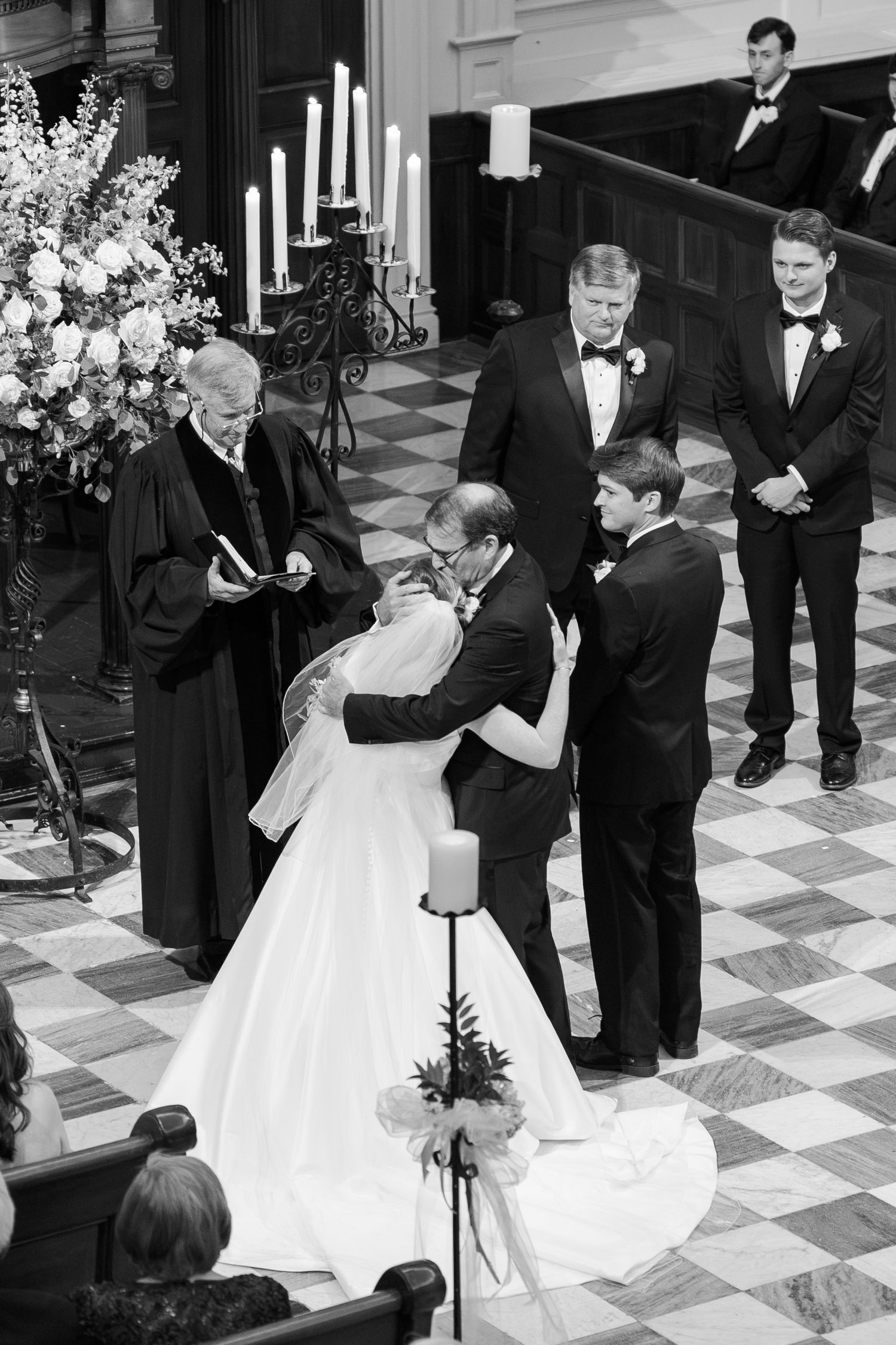 Black and white photos of a traditional wedding ceremony on a checkered marble floor.