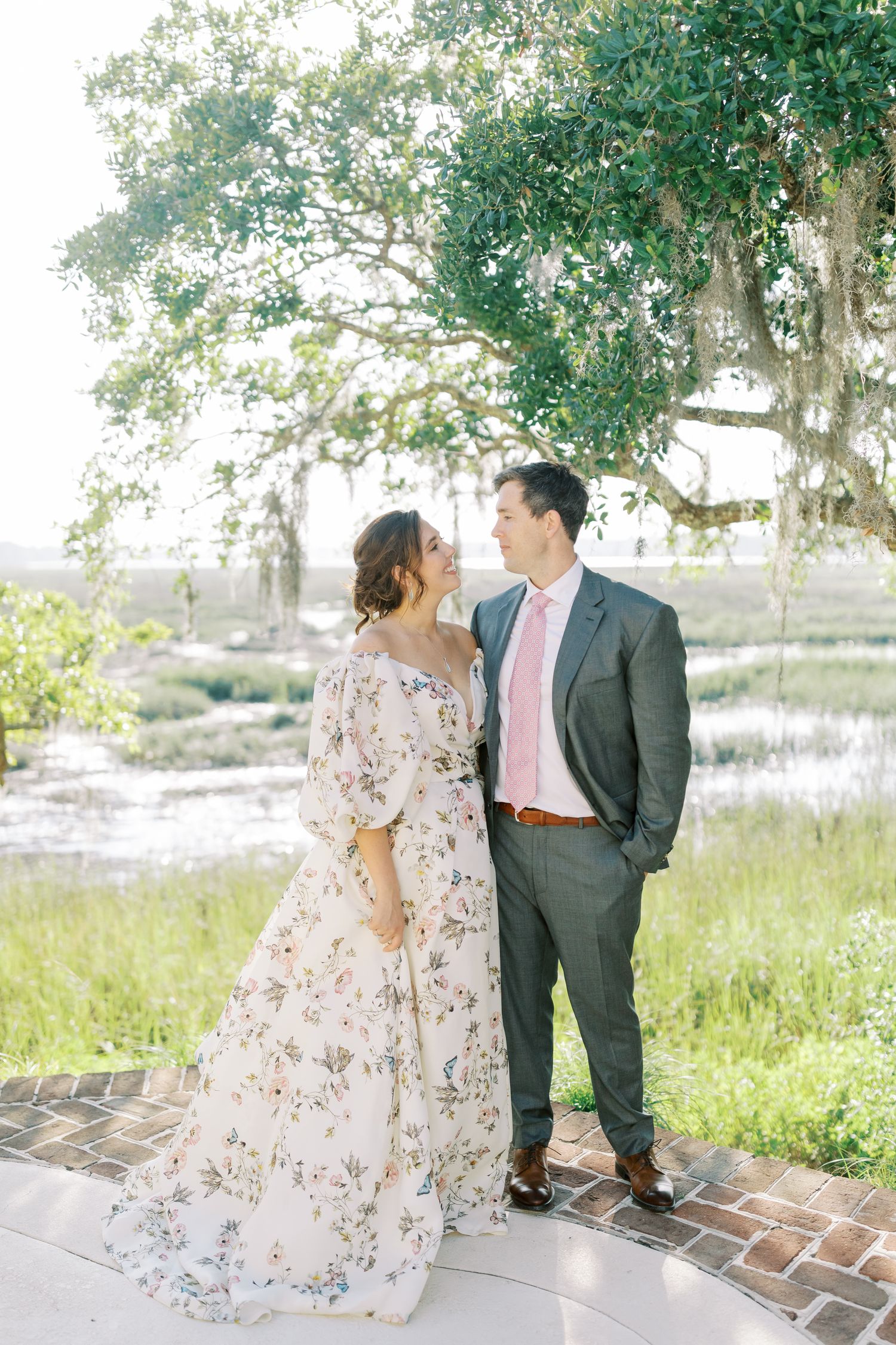 A romantic outdoor photo session among moss-draped trees and marsh grass.