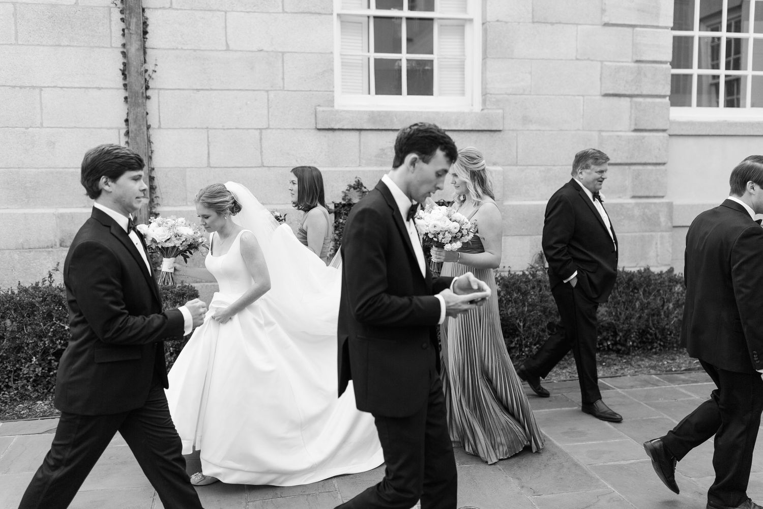 A series of black and white wedding photos showing couples dancing together at a formal reception.