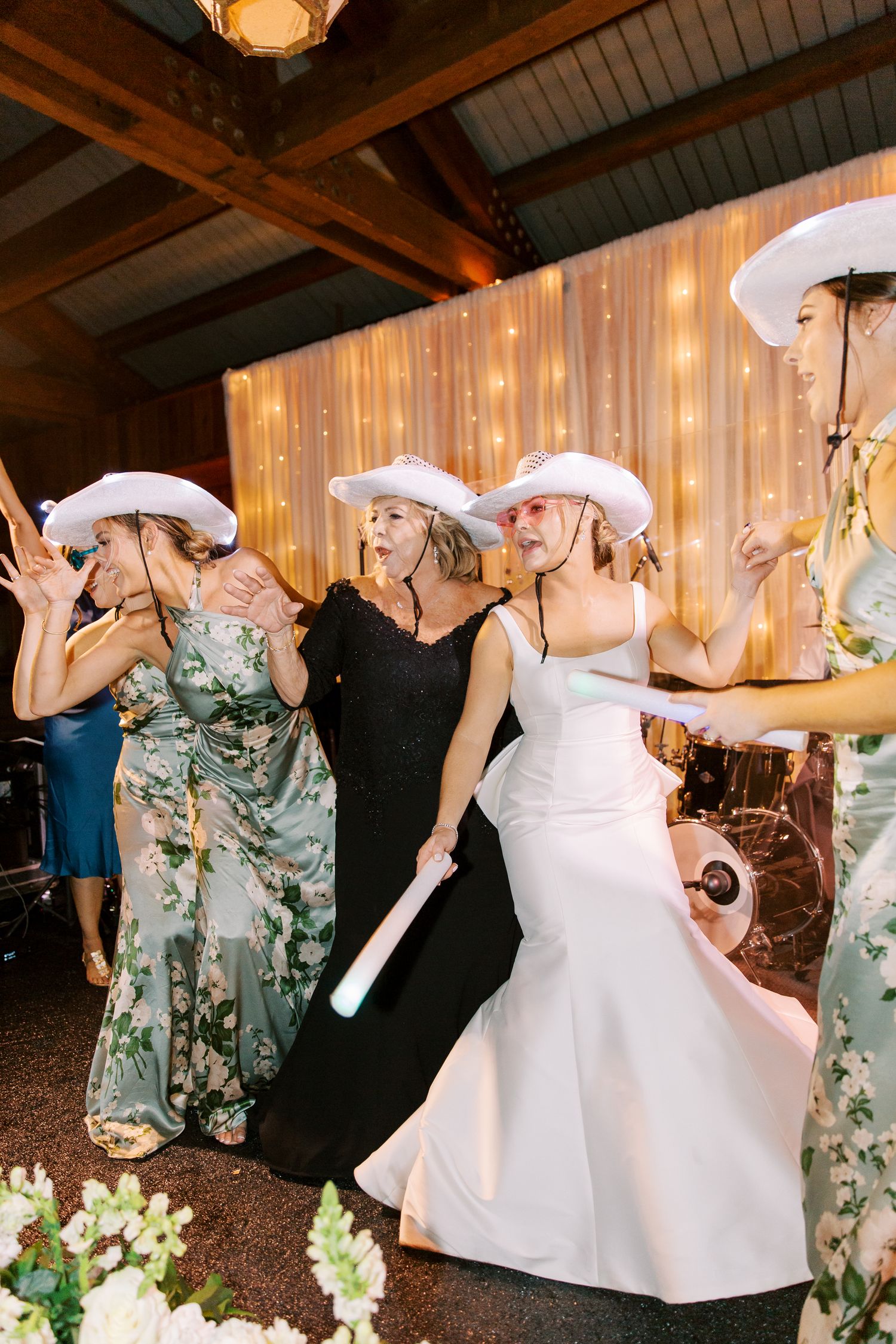 Wedding party wearing white cowboy hats dancing and celebrating at a reception at Frederica Golf Club in St. Simons.
