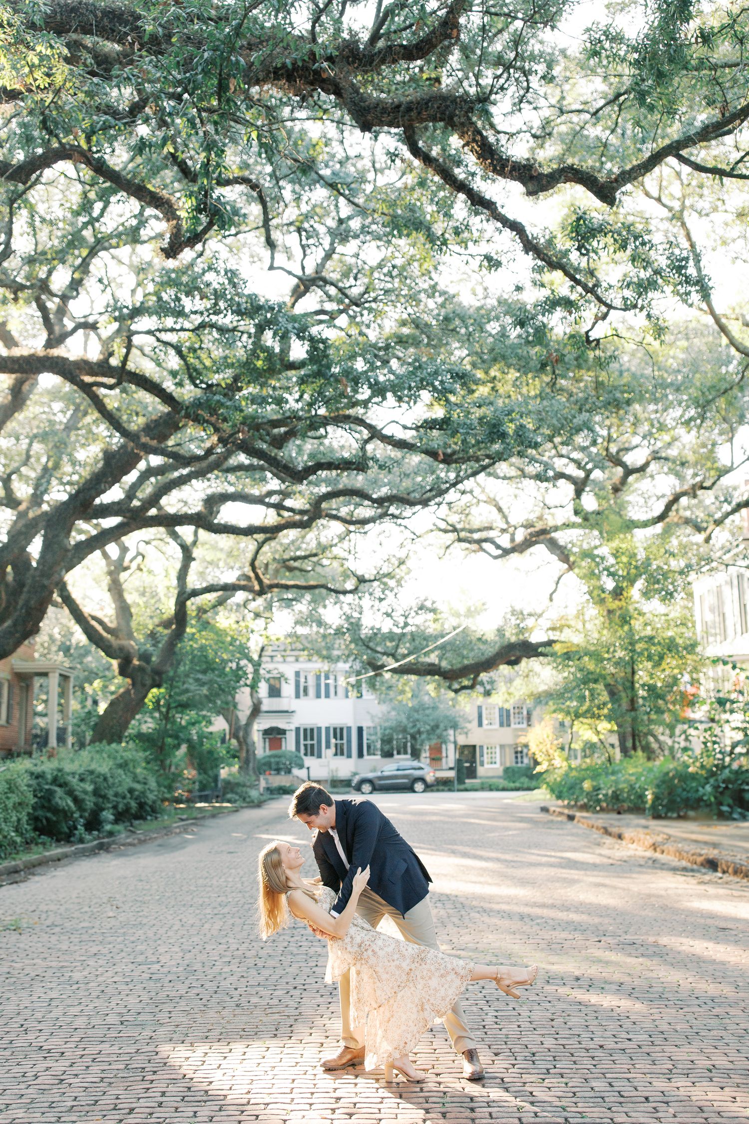 A romantic dip kiss under moss-covered oak trees on the cobblestone covered Jones Street.