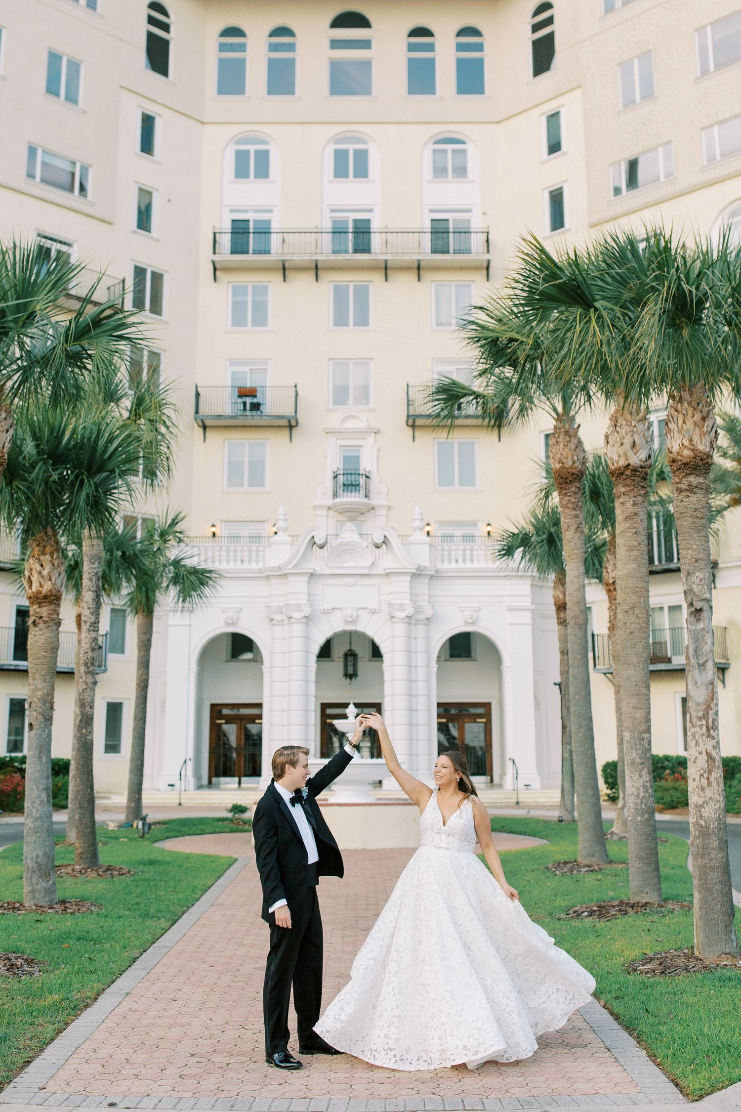 Celebratory moment outside historic building with palm trees.