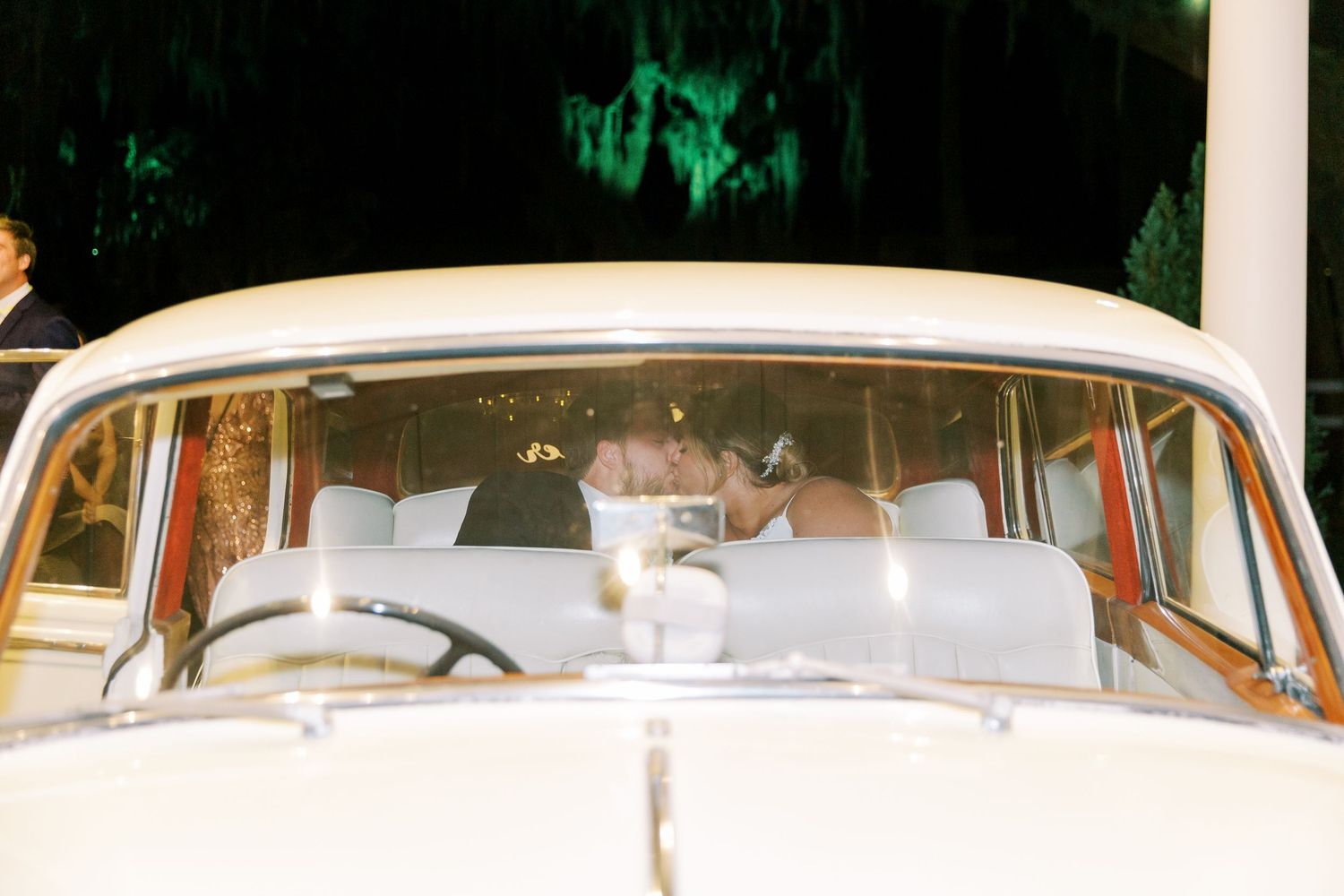 View through windshield of classic white vintage car decorated for wedding transportation.