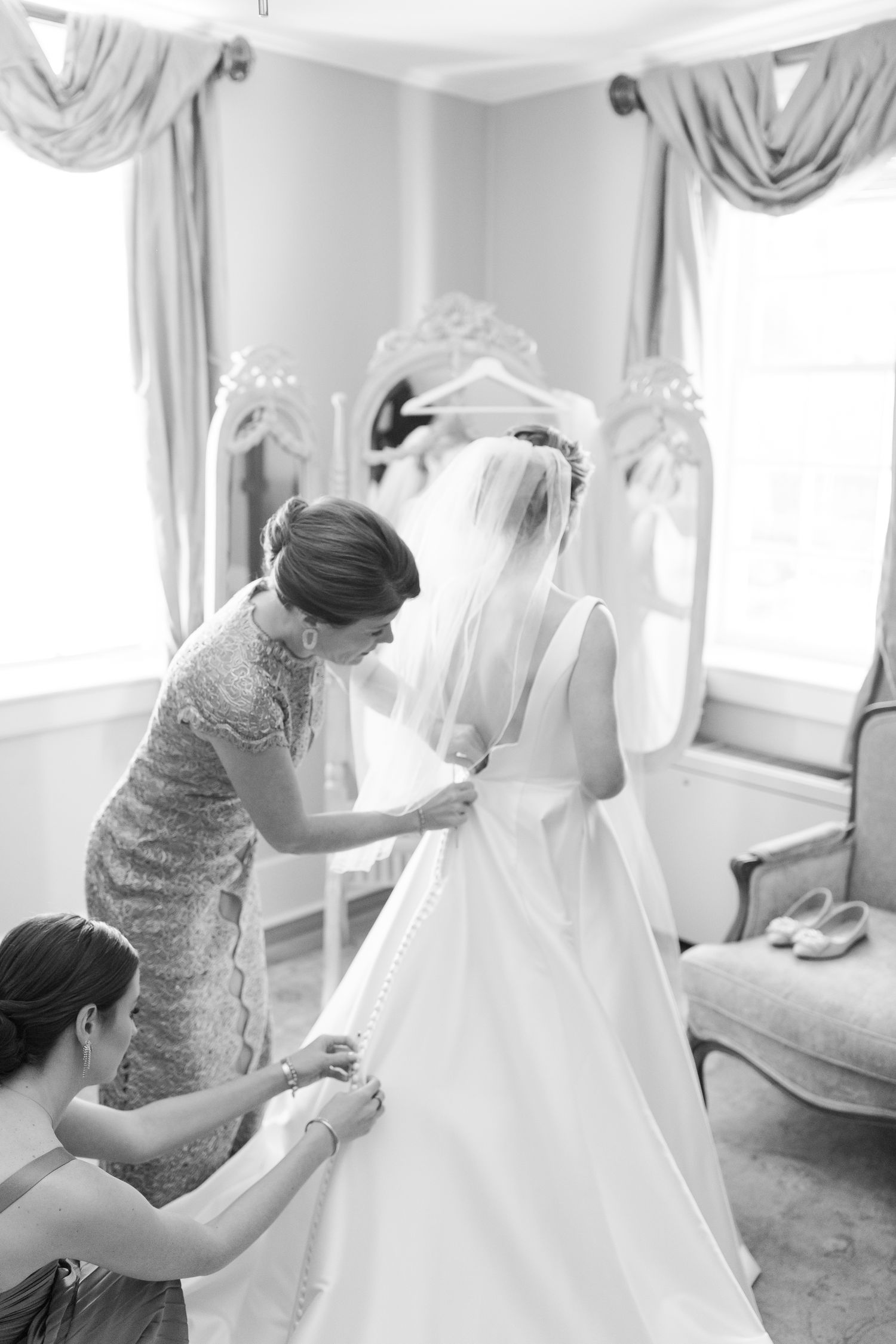 Wedding dress preparation sequence showing final adjustments and details in a sunlit dressing room.