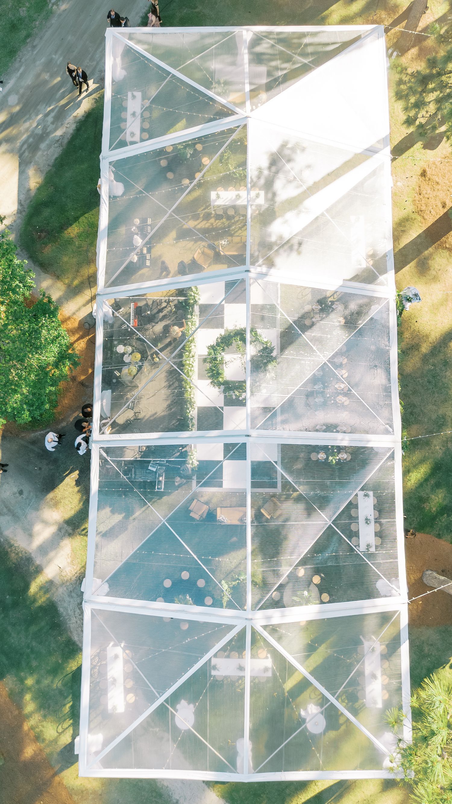 Aerial view of a clear tent with geometric patterns and checkered dance floor.