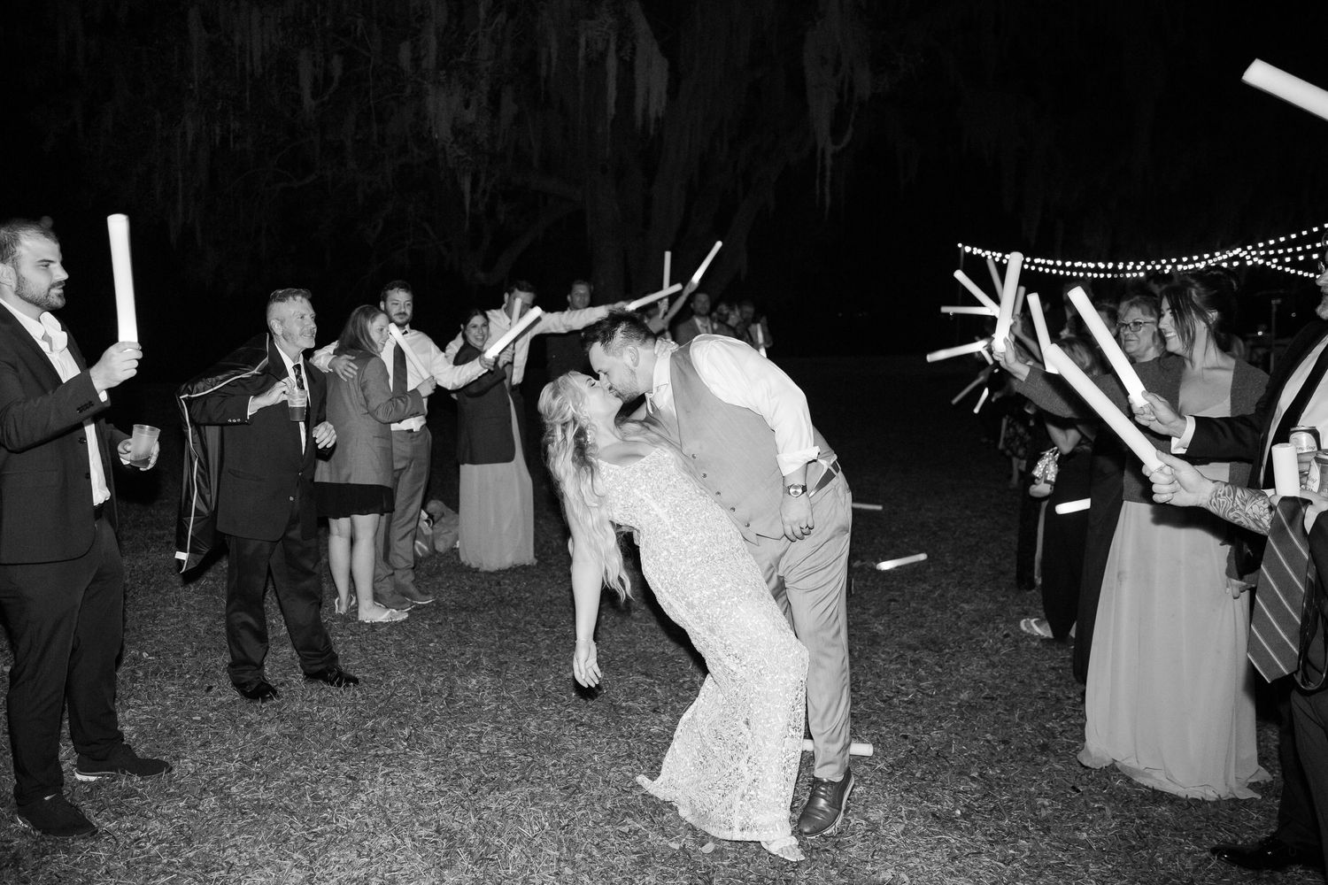 Black and white photo of wedding sparkler exit with couple sharing romantic moment.